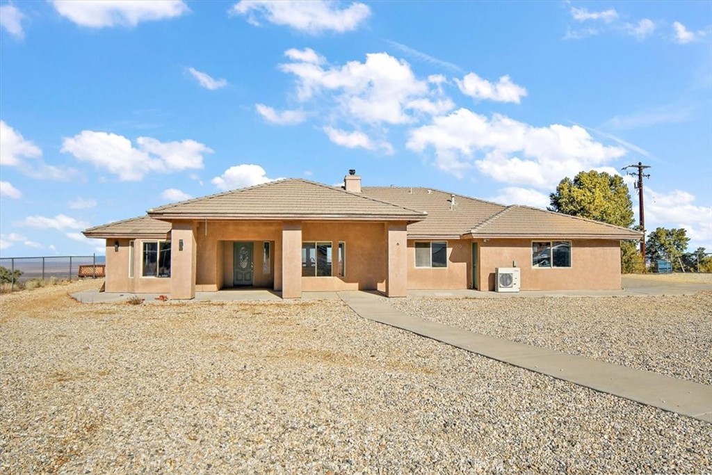 Spacious 4-Bedroom Retreat on Nearly 5 Acres with Stunning Views in Private Pinon Hills! Welcome to your dream home in the serene city of Pinon Hills! Nestled on just under 4.5 acres of pristine land, this beautifully maintained 4-bedroom, 2-bathroom residence offers the perfect blend of comfort, functionality, and wide-open space. Inside, you'll find a bright and open floor plan with generous living areas, ideal for both relaxing and entertaining. The well-appointed kitchen flows effortlessly into the dining and family rooms, while the bedrooms provide ample space and privacy for the whole family. Car and RV enthusiasts will love the attached 3-car garage and two massive RV garages, providing extensive room for vehicles, storage, or even a workshop. Whether you need space for your toys, hobbies, or home business, this property has you covered. Step outside to enjoy breathtaking panoramic views of the surrounding desert and mountains—perfect for sunrise coffees or sunset gatherings. With nearly 5 acres of usable land, the possibilities are endless—add a pool, build a guest house, or simply enjoy the peaceful open space. Don't miss this rare opportunity to own a spacious and private estate with unmatched amenities and room to grow—all in the quiet, desirable community of Pinon Hills.