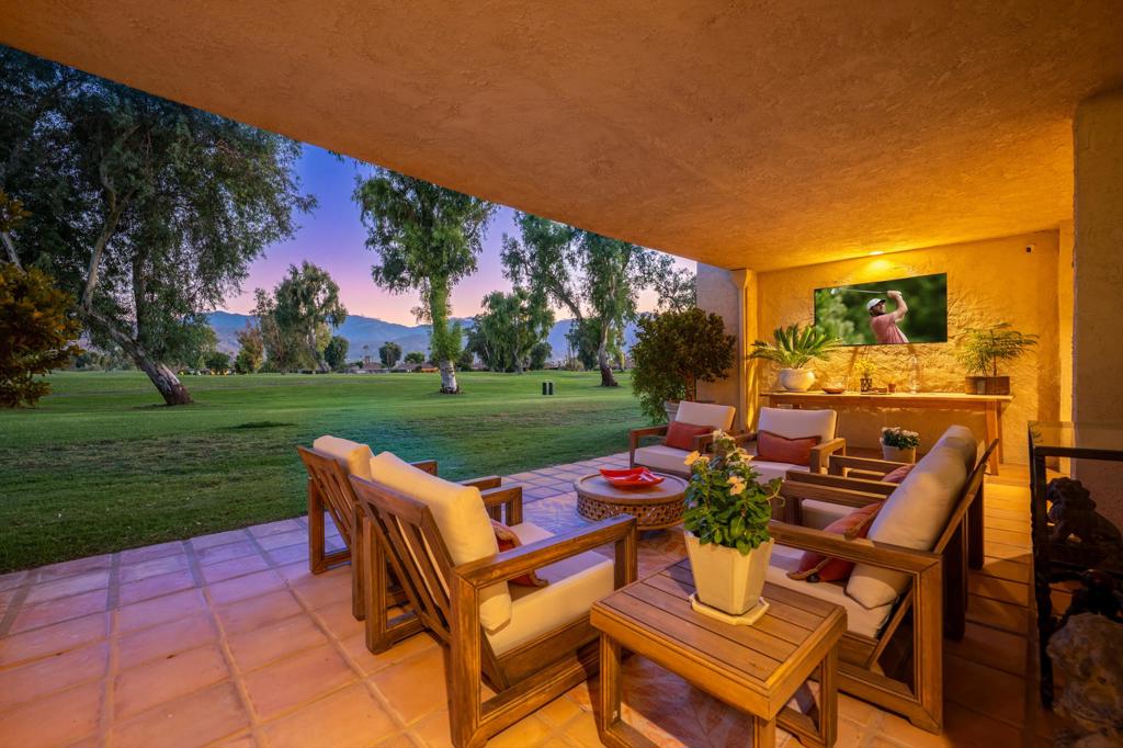 Located on a premium end unit lot in the world renowned Mission Hills CC this 4B/3.5BA home with two private offices is a rare offering that blends luxury functionality and stunning views. Overlooking the 9th hole of the Dinah Shore Championship Course, it provides unobstructed south-facing views of the Santa Rosa Mountains and sunsets over the San Jacinto range from a private setting with no neighbors behind. The layout features vaulted ceilings, a dramatic raked plaster-style fireplace inspired by mid-century design, and expansive views from nearly every room. Each bedroom opens to a private patio while two custom offices, including one with a separate exterior entrance, provide ideal spaces for remote work, creative use, or retreats. The home has been extensively remodeled with designer finishes, including 24x48 ceramic tile floors, new cabinetry, slab quartz counters, and premium KitchenAid appliances. The kitchen includes Kraus stainless sinks and faucets, custom drawer organizers, and track lighting along ceiling beams. A custom bar and media room with a dual-temperature Zephyr beverage fridge and U-Line ice maker creates a perfect entertaining space. Upgrades such as a Sonance 7.1 surround sound system, motorized shades, and refined details throughout enhance the living experience. Additional features include an oversized laundry room with a stainless steel dog bath, quartz counters, and storage, plus a 400-amp panel with updated circuitry for modern efficiency. There is a 2-car garage and a separate golf cart garage, each with storage, including bike racks. The property is close to the clubhouse, where residents can enjoy pickleball and tennis courts, a fitness center, and a calendar of social events. The home has been pre-inspected with a full report available, underscoring the quality of the improvements. Efficiency features include Nest thermostats, LED lighting, new HVAC, and a tankless water heater. This is a unique opportunity to own a home that combines privacy, luxury, mountain and golf course views, and the vibrant lifestyle of Mission Hills Country Club. The 2121 land lease extension has been paid for your added piece of mind. Don't miss out on this excellent opportunity on this one-of-kind property. Schedule your private tour today!