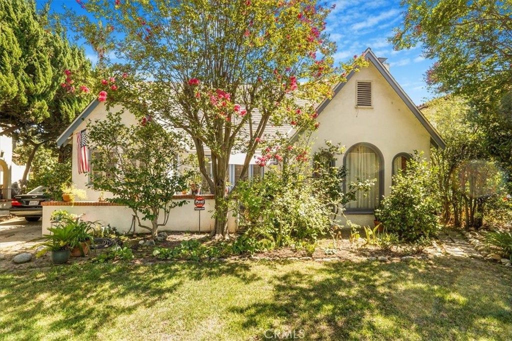 Welcome to this 1862 sq ft. storybook English Cottage style home nestled on an OVERSIZED 8859 sq ft. lot in the HIGHLY DESIRABLE CASA GRANDE neighborhood, part of PASADENA'S HISTORIC EAST ORANGE GROVE-LAMBERT DISTRICT-- a peaceful, tree-lined enclave known for it's majestic canopy streets, charming architecture, and community pride. Located between ALLEN AVE and ALTADENA Dr. with top rated magnet and public schools, close to dining and local shops. Step inside to find original 1926 wood floors, arched original thick wood trimmed, beautiful, windows all throughout the house! And many special period details. An abundance of natural light flooding the living spaces, with a spacious front dining room featuring double french doors that open to a private, partially enclosed, front patio --perfect for morning coffee or evening gatherings, taking in the view of the beautiful SAN GABRIEL MOUNTAINS. There is even an additional room to use a home office or a sewing room or.... You have options! The customed tile Batchelder fireplace, crafted by the renowned american artist, adds a one-of-a-kind, beautiful, focal point. The beautifully renovated bathroom showcases custom tilework by the same renowned american artist and includes a walk in shower. The home offers central heat and AC, a walk in pantry, with pull down stairs to the very spacious attic for storage or possible expansion of a second story. An in-door laundry room with potential to convert into a second bathroom. The primary bedroom french door, opens to a back covered porch and a LUSH GARDEN BACKYARD, which feels like your own private orchard--offering a variety of fruit trees, lemon, orange, grapefruit, peach, apple pear, persimmons, kumquat, strawberries, zucchini and much more. A DETACHED 2 CAR GARAGE offers potential for an ADU if desired. Surrounded by year round beauty, don't miss your chance to own a timeless piece of Pasadena charm in one of its most exclusive and admired neighborhoods. Offered at a great price. Seller has found a home and is ready to move. Come and take a look at this beauty.