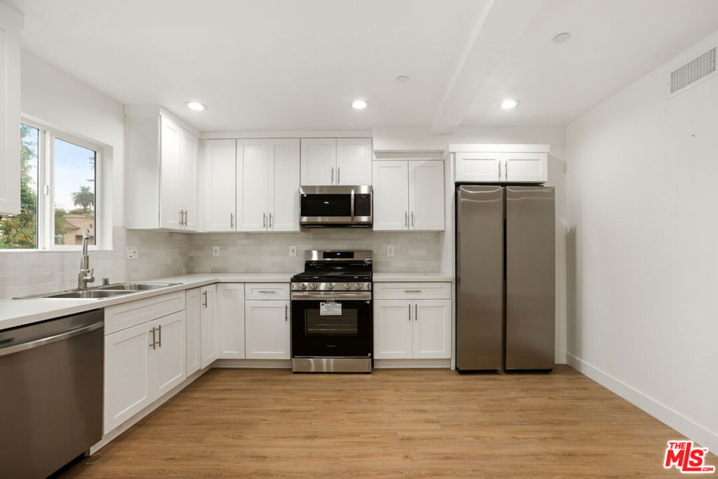 Step into 4232 Rosewood Ave Los Angeles, CA 90004, a sleek and sunlit 2-bedroom, 2-bathroom unit located in the heart of East Hollywood. This thoughtfully renovated residence boasts wide-plank vinyl floors, recessed lighting, and oversized windows that flood the space with natural light. The open-concept layout creates a seamless flow from the spacious living area to the modern kitchen, offering both comfort and functionality for today's urban lifestyle.The kitchen is a standout, featuring white shaker cabinetry, quartz countertops, and a full suite of stainless steel appliances including a gas range, microwave, dishwasher, and French-door refrigerator. Each bedroom offers generous closet space and privacy, with the primary suite including its own en-suite bathroom and the second bedroom situated near the second full bathperfect for guests or roommates. Clean lines and contemporary finishes throughout make this unit completely move-in ready.Additional highlights include central HVAC, in-unit laundry hookups, and secure gated access within a low-density building. With its prime location near Larchmont Village, Silver Lake, Los Feliz, and convenient access to the 101 Freeway and Metro Red Line, Unit #4232 offers unbeatable convenience and style. Disclaimer: Broker/Agent does not guarantee or warrant the accuracy of the square footage, lot size, or other information concerning the condition or features of the property. Broker/Agent is not responsible for any inaccuracies contained herein. Tenant and/or buyer is advised to independently verify all information.