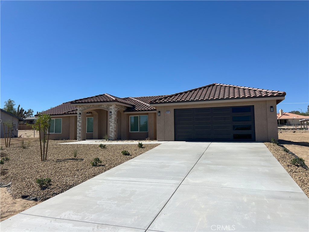 New Construction Home in Victorville on a large .41 ac lot. 1,871 square foot custom home with 4 bedrooms, 2 bathrooms and a 2 car garage. Upon entering the home, you are greeted with a large, open and inviting great room. Just off the great room is the dining area and beautiful kitchen. Gorgeous countertops, stainless steel appliances, full backsplash and a raised bar area highlight the kitchen. Just off the great room on the garage side is access to the garage via walkthrough laundry area. Laundry room has plenty of cabinets and room to customize specific mud room needs. Next to the laundry room is the Master Bedroom, with large walk in closet providing plenty of shelves and racks, and the Master Bathroom with double sinks, tub and walk-in shower. On the opposite side of the Great Room is a hallway leading to three additional bedrooms and the secondary bathroom, complete with the convenience of double sinks. Outside the secondary bathroom is a nook with cabinets and countertop. All bedrooms have closets with shelving and multiple racks. The backyard has plenty of room for your vision and comes with patio and patio cover. Added bonuses also include window coverings and Solar Panels, both included in asking price. Don't pass on your opportunity for a great new construction home at a great price. Adjacent New Construction home available as well. Buy both and have a family compound! Homes will be available for private walkthroughs starting October 9. Call or text listing agent to schedule. Will be move-in-ready by the end of the month.