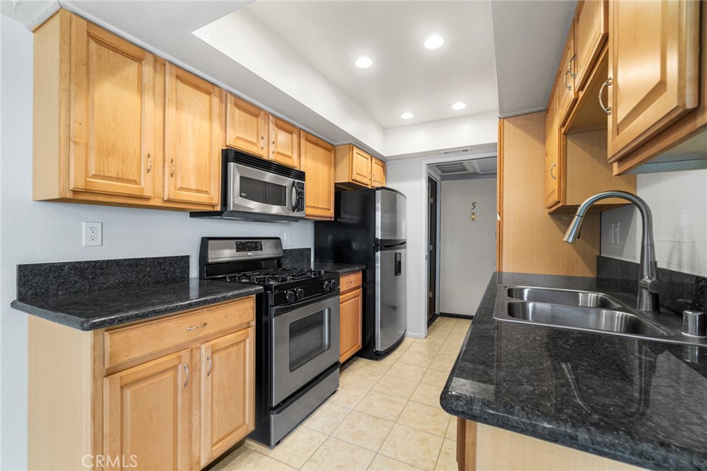 Spacious, Secure, and Move-In Ready!
Welcome to this beautifully maintained second-floor condo tucked inside a gated, 16-unit complex offering security, privacy, comfort, and convenience. With approximately 1,119 square feet of thoughtfully designed living space, this 2-bedroom, 2-bath home blends smart function with elegant design.
Step into a welcoming tiled entry with built-in storage cabinets, leading you through the kitchen and dining areas to a generously sized Living Room. The Living Room features soft carpeting underfoot, built-in cabinetry with mirrored glass shelving, and a cozy gas fireplace—ideal for relaxing or entertaining. The upgraded kitchen boasts rich maple cabinets, sparkling black granite countertops, and a full suite of stainless-steel appliances including a free-standing oven/range, refrigerator, microwave, dishwasher, and deep sink. The adjacent dining area opens to a private balcony through sliding glass doors, bringing in ample natural light. Down a carpeted hallway, discover the serene sleeping quarters. The spacious Master Bedroom offers carpet, ample closet space, and a private en-suite bathroom complete with a walk-in tiled shower. The second bedroom—also carpeted—is just steps from the hall bath, which features a shower/tub combo. A dedicated, tiled indoor laundry room adds to the convenience.
Additional highlights include:
- Two dedicated parking spaces in a secured garage
- Elevator and stair access to all levels
- Carpeted hallway, bedrooms, and Living Room for comfort and warmth
- Tile flooring in entry, kitchen, bathrooms, dining area, laundry, and one hallway (condo has two hallways)
- Gated security building entrance and peaceful interior courtyard with potted trees
This condo has been well cared for and is move-in ready. Located close to Harbor Freeway, Harbor College, Kaiser Hospital, dog park, shopping, restaurants, a lake park, theaters, and the ocean—everything you need is just minutes away. Don't miss your chance to call this comfortable, secure condo your new home.