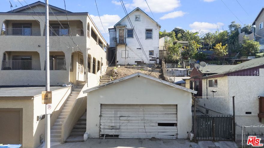Unique investment opportunity with a million dollar view.  Calling investors and developers to up-and-coming Boyle Heights. Single family home with a detached 2-car garage and alley access. The fixer property is zoned LAR2 and faces West - rendering views of the Downtown L.A. Skyline. Across the street from the Boyle Heights Sports Center & Park.  A stone's throw away from Downtown L.A., the Arts District and Little Tokyo via the 6th Street Bridge. Centrally located with easy access to the 5 and 10 freeways, and public transit.  Sold AS-IS - cash only - this home does not qualify for financing. This is a standard sale, not a probate or foreclosure.