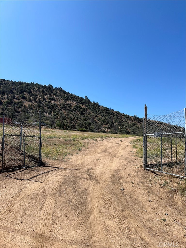 2.5-Acre Fenced Lot in Tranquil Sand Canyon | Tehachapi, CA
Tucked away in the quiet community of Sand Canyon, this 2.5-acre fenced and graded lot offers privacy, natural beauty, and endless possibilities. Located just minutes from the Sand Canyon entrance and about half a mile from the main road, it's the perfect blend of seclusion and accessibility.
The property features a driveway, small trees planted by the current owner, a trailer, an insulated shipping container, a patio cover, three water tanks (for water to be trucked in), and a septic tank, all added without permits. Buyer and buyer's agent are advised to perform their own investigations.
Enjoy sweeping canyon views, visits from local wildlife, and starry skies that come alive at night. Just under 10 minutes from the peaceful Mountain Spirit Zen Center, this lot is ideal for those seeking a quiet retreat or a future build site surrounded by nature.
Don't miss this chance to own your own peaceful escape in Sand Canyon.