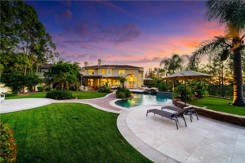 Experience luxurious living in this rare end-unit estate nestled within the prestigious 24/7 guard-gated Summit Pointe community. Situated on nearly HALF AN ACRE, it’s one of the most private lots in the community. It is the only home with a gated front yard, private long driveway, and its own electric gate. The home’s elevated, secluded position offers unmatched privacy that is barely visible from the street. This private oasis offers over 180-degree, nearly 100 yards of UNOBSTRUCTED VIEWS of city lights at night and beautiful snow-capped mountains during the winter. Inside, the seller spared no expense, investing over $750,000 in a full-scale remodel using top-notch materials and designer finishes throughout. From the moment you enter through the dramatic foyer, you're greeted by soaring cathedral ceilings, a striking modern glass-pane staircase, and an abundance of natural light filling the expansive living spaces. Interior highlights include: Grand formal living and family rooms with custom wall treatments and upgraded fireplaces. Fully remodeled kitchen with new custom cabinetry, built-in microwave, dishwasher, and full-house water filtration system. A spacious en-suite bedroom on the first floor, ideal for guests or multigenerational living. The primary suite upstairs is an elegant retreat featuring a dual-sided fireplace with a private sitting area, and his/hers walk-in closets. All 5 luxurious bathrooms are remodeled with premium fixtures and finishes. A large loft upstairs plus a bonus room perfect for a fitness studio, office or playroom. Additional upgrades include premium flooring and baseboards, fresh interior paint, stone-accented feature walls, and plantation shutters throughout, upgraded HVAC system, water heater, newer second-floor windows, modern light fixtures and recess lights throughout, and fully finished 3-car garage with resurfaced flooring. Beyond the interior, the backyard is a resort-like masterpiece. The expansive outdoor oasis was designed for both entertaining and relaxation and includes upgraded pool/spa, water feature, outdoor kitchen, pickleball/basketball courts, with additional space for potential ADU, and the property's own private automatic gate in addition to the community guard-gate. This home is a true showpiece where modern luxury meets resort-style living with access to top-rates schools. A rare opportunity to own one of the most iconic properties in Summit Pointe with unparalleled views, privacy, and quality.