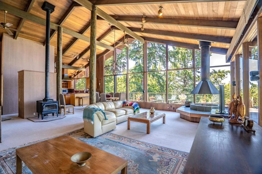 Step inside and step back in time to this to this stunning Henrik Bull-style home in Skywood Acres, where classic charm meets modern comfort. Nestled in a sunny tranquil setting, this architectural gem opens into a breathtaking great room with cathedral ceilings and walls of windows that frame sweeping treetop views. This seamless blend of indoor/outdoor living extends to an expansive deck offering a perfect retreat that harmonizes with nature. Reminiscent of a mountain ski lodge, this 2510 sqft private haven enjoys its own sunny microclimate and offers the ultimate escape, just 14 minutes to 280, 25 minutes to Stanford, minutes from Alices Restaurant, and private access to Wunderlick Park, Portola Valley schools. Main home features a primary bedroom that includes bathroom, dressing room and private office. Main level boasts a well-appointed kitchen, custom wood built-ins, opens to a grand living area. Downstairs 2 bedrooms and bath, 3 car garage with wine closet. Detached guest studio with sleeping loft. 1.5 acre lot includes a former sport court ready for new possibilities Make this getaway your private Shangri-La