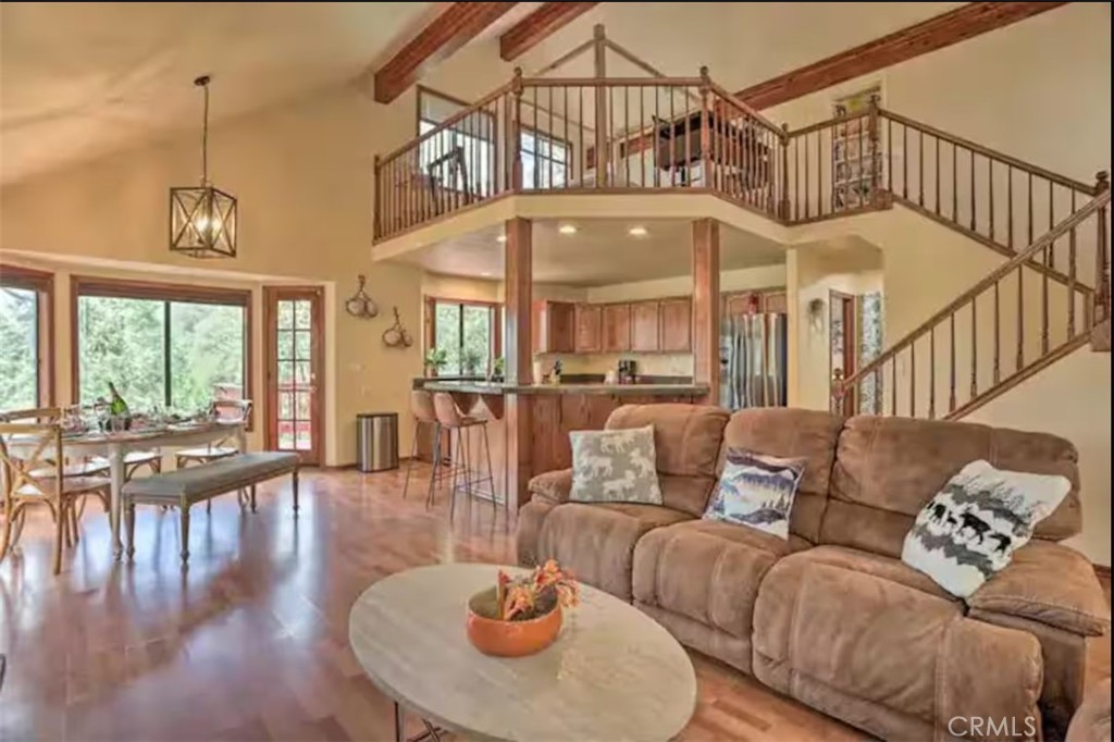 Welcome to this stunning 2,320 sq. ft. mountain retreat in the heart of Crestline, just 5 minutes from Lake Gregory and a short drive to Lake Arrowhead and SkyPark. This multi-level fully furnished chalet offers breathtaking views, modern upgrades, and exceptional indoor and outdoor living spaces. The entry level features a spacious living room, a king-size bedroom with a walk-in closet, a full bathroom, a fully equipped kitchen, and a wraparound deck perfect for enjoying the serene surroundings with mesmerizing views of Mount Baldy and the forest. Upstairs, a cozy loft with a queen-size bed provides additional sleeping space. The second level showcases a luxurious primary suite with an ensuite spa bathroom, including a double hot tub, and private deck access. The lower level is an entertainer’s dream, featuring a large game room with a pool table, darts, board games, and a separate entertainment area. A kitchenette, full and twin bunk beds, and an additional full bathroom complete this versatile space. Step outside to the expansive lower deck, equipped with a BBQ grill and outdoor seating—ideal for al fresco dining and entertaining. With easy access to hiking, lake activities, and winter sports, this property is perfect as a primary residence, vacation home, or investment property. Don’t miss this opportunity to own a turnkey mountain retreat in a prime location. Schedule a showing today! Plans for an attached 612 square feet ADU with a bathroom and full kitchen as well as carport have been approved but may be expired: buyer to investigate.
