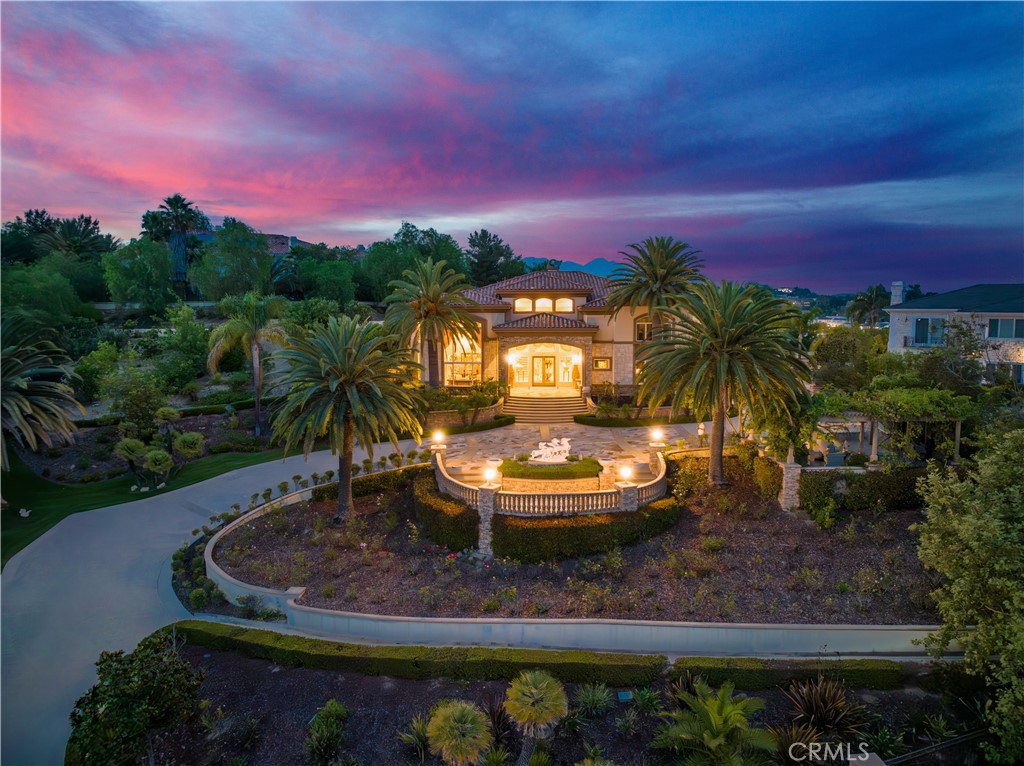 A One-of-a-Kind Estate Offering Unmatched Privacy, Immersive Entertainment & Breathtaking Natural Beauty
This magnificent custom-built tri-level estate—meticulously crafted with multi-million-dollar investments—is located in the prestigious 24-hour guard-gated community of The Country Estates, nestled on a serene street. Perched on one of the community’s rare flat, elevated lots, it features the only oversized and fully landscaped front yard of its kind, offering a level of grandeur and privacy rarely found in the area.
As you pass through the private gate, you’re greeted by a truly spectacular scene: eight soaring palm trees like celebratory fireworks, an expansive botanical rose garden filled with rare varietals, and a fruit orchard hosting nearly every kind of fruit tree imaginable. On clear days, the front yard offers distant ocean views, while the backyard reveals snow-capped mountain vistas in early spring—a breathtaking natural contrast that changes with the seasons. With space to park over 20 vehicles, the front court offers the perfect setting for grand gatherings without compromising privacy or elegance.
Inside, the home is equally impressive: outfitted with 13 built-in surround sound systems and two professional-grade home theaters valued at $400,000—one with a 7.1 surround system in the family room, and another as a fully dedicated private cinema. Designed for the true audiophile and film enthusiast, this is immersive entertainment at its finest. The home is also upgraded with smart-home features, allowing lighting, climate, Garage doors,and security systems to be conveniently controlled via smartphone or tablet—seamlessly blending luxury with modern technology.