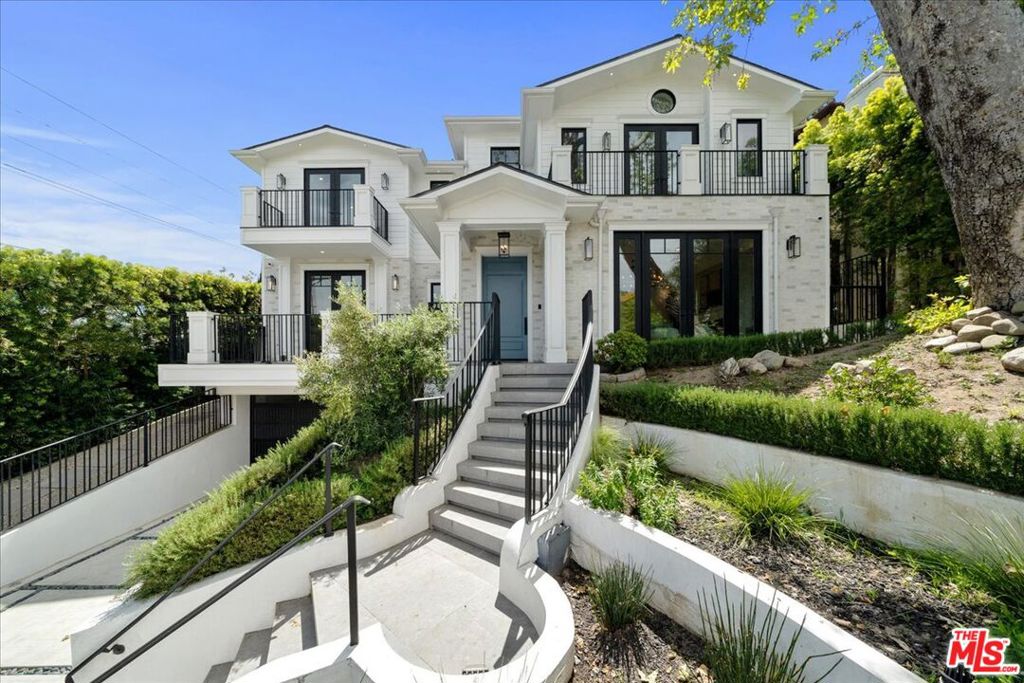 A stunning custom-built residence located in the desirable Cheviot Hills area, this exceptional home offers a fabulous blend of luxury, functionality, and design. Boasting 7 bedrooms and 7.5 bathrooms, including a fully equipped standalone ADU with its own kitchen and full bath which is included in the bedroom count, this apx. 5,341-sq.ft. estate is a showcase of meticulous craftsmanship and refined details. Step inside to discover wide plank white oak floors, elegant marble accents, and hand-painted wallpaper by Lilly Nemani Designs. At the center of the home lies a serene outdoor oasis, complete with a tranquil pool, spa and cascading waterfall. The open-concept layout seamlessly merges indoor and outdoor living, allowing sunlight to pour into every corner. The formal great room, anchored by a striking fireplace, opens to the lush backyard and flows directly into a chef's kitchen that leaves nothing to be desired. Highlights include a marble-topped island with a hidden motorized TV, Wolf appliances, dual Subzero refrigerators and freezers, two sinks, two dishwashers, a walk-in pantry, and twin refrigerated wine fridges. The breakfast nook offers a bright, cozy spot with views of the garden. Upstairs, the primary suite offers a luxurious retreat with soaring ceilings, a private balcony, custom cove lighting, and dual walk-in closets. The spa-like primary bath features marble flooring, a dedicated marble dressing vanity, dual vanities, dual secluded water closets, a marble-clad shower with rain and handheld showerheads, custom inlay marble accents, and a freestanding soaking tub with hand shower. The lower level is perfect for relaxing or entertaining, with ample space ideal for a home theater, game room, or playroom. Additional features include a paneled three-story elevator, a dedicated home office with full bath and closet, a laundry room with LG appliances, glass-enclosed wine storage, spacious balconies, walk-in closets throughout, and a premium whole-home sound system. Just minutes from Rancho Park Golf Course, exclusive country clubs, and top-rated schools, this rare offering in one of L.A.'s most sought-after neighborhoods is ready for its first owners to move in and make it their own.