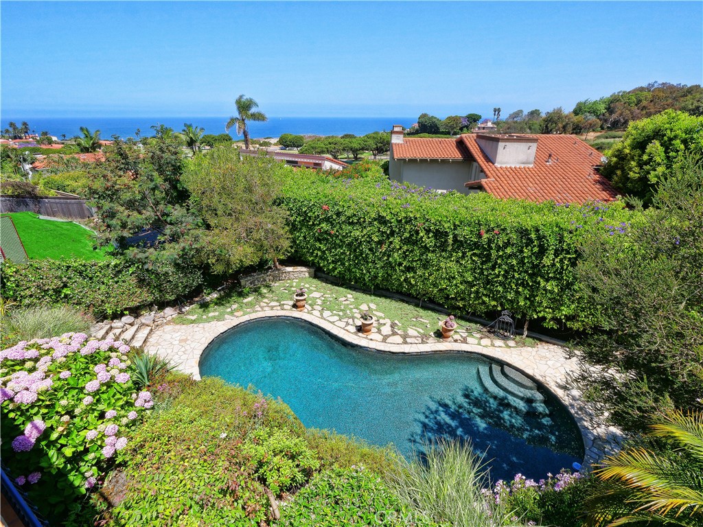 Enjoy unobstructed views of the Santa Monica bay and mountains and lush landscaping from all but one room in this very private Malaga Cove retreat.
Although this home was originally constructed in the early 1950's, it was taken down to the studs in the 1990's and rebuilt and enlarged with marvelous attention to detail and more upgrades as recently as 2019! Gorgeous wood floors, open space, skylights, 3 bedrooms with private baths and a fourth bedroom with a full bath nearby 4 total baths: 2 full & 2 3/4 baths). Huge open plan living room with views of the Bay and a large balcony and fireplace, great family room with views, fireplace and access to a second large view deck, spacious master suite with views from a private view balcony, large walk-in closet, bath with separate spa tub and separate shower, great bedroom or office near the master suite with large closet and full bath, huge third bedroom (as big as the primary!) with its own bath and access to the view deck. Private front courtyard with waterfall and rear yard with a very private saltwater pool with water feature. And this special oasis is near everything! Walk to the beach! Walk to Malaga Cove shops and restaurants and library! And of course close to award winning schools, abundant recreation and the wonderful cool clean air that makes Palos Verdes Estates a great place to live.