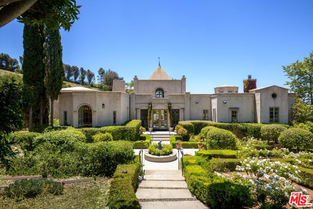 Elegance meets tranquility at this stunning Palladian style estate in Montecito. Custom built by craftsmen in 1996 to last for centuries, the architectural elements add character and offer timeless appeal. Spanning an impressive 4,018 square feet with 4 bedroom/5 baths, this unique Italianesque residence showcases picturesque ocean views and peaceful mountain vistas.Step inside to discover interiors adorned with original iron fixtures, classic lighting and wide plank authentic Douglas fir floorsall showcasing a rich patina that adds timeless character. The main floor has a historic cruciform layout with two companion fireplaces at each end anchoring the great room and adjacent oversized dining room, creating a warm and ambient atmosphere for gatherings and setting the tone for a grand retreat. An impressive wrought iron chandelier adorns the soaring vaulted ceilings in the center. A formal power room greets you upon entering the home. The charming original ocean view kitchen has a classic layout with a traditional center table with easy flow to the dining and great rooms.On the primary wing you will find the oversized private suite with high vaulted ceilings with cozy fireplace. There is no shortage of closets and a spacious spa like bathroom. Two additional well appointed guest rooms with en suite bathrooms also reside on the main level.The expansive back terrace offers an ideal setting for al fresco dining and relaxation where you can soak in the stunning ocean and mountain views while enjoying the gentle coastal breeze. Or escape to the cozy glass window enclosed conservatory off the living room to connect with nature, meditate or relax with a book.The lower level retreat offers an oversized private apartment with a well-equipped kitchen and family roomperfect for extended family or accommodating guests. The separate entrance ensures that visitors can enjoy their stay without intruding on the main living spaces.As you explore the nearly one acre grounds, you'll be captivated by the vast gardens that surround the estate with plenty of room to expand on the existing landscaping or add a pool or ADU.This property embodies a traditional legacy estate compound offering incredible upside potential and the relaxed Montecito lifestyleperfect for those who appreciate the harmony of luxury and nature. Experience the best of both worlds in this serene and sophisticated haven.