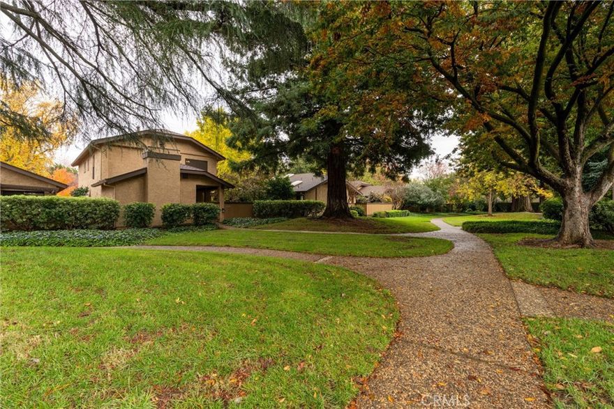 Wonderful, quiet Chico location in the lovely Woodcrest complex, where you’re surrounded by mature, lush landscaping and beautiful redwoods. This charming condo offers 3 spacious bedrooms and 2.5 bathrooms, along with a welcoming layout that feels warm and inviting from the moment you step inside. The living room features high ceilings and a gorgeous brick fireplace that truly anchors the space. The kitchen is adorable and perfect for entertaining, offering a cozy dining nook plus an additional room that connects to the kitchen—ideal as a formal dining room, office, or comfortable sitting area. Upstairs are two generous guest bedrooms and a guest bathroom with new flooring. The large primary suite features a dual-sink vanity, lots closet space, and new flooring as well. One of the best highlights is the incredible, oversized fully gated and covered patio—your own private retreat. Relax in the hot tub or unwind while enjoying the peaceful, beautifully landscaped surroundings. Additional features include a two-car attached garage and access to the community pool, perfect for cooling off during Chico’s hot summers. Close to shopping and everyday conveniences, this condo is ready to become a beautiful place to call home!