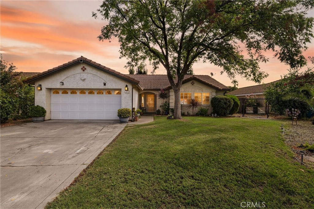 Welcome to a home that brings together comfort, space, and location. This 3-bedroom, 2-bathroom residence offers 1,504 square feet of well-designed living space with an open-concept layout and tall ceilings that make every room feel light and welcoming. A Spanish tile roof adds both style and lasting durability, while the attached two-car garage provides convenient parking and storage. The primary bedroom features its own private bathroom, offering a retreat-like experience. Two additional bedrooms provide options for guests, a home office, or hobbies—whatever suits your lifestyle. Step outside to a generously sized backyard, ideal for relaxing, gardening, or weekend barbecues if you’re feeling grill-inspired. Positioned in a desirable Orland neighborhood, you're close to parks like Lollipop Land, schools including Orland High, and everyday conveniences such as grocery stores and restaurants like The Hive Kitchen & Bar. With easy access to commuter routes, this home complements daily life with simplicity and charm.