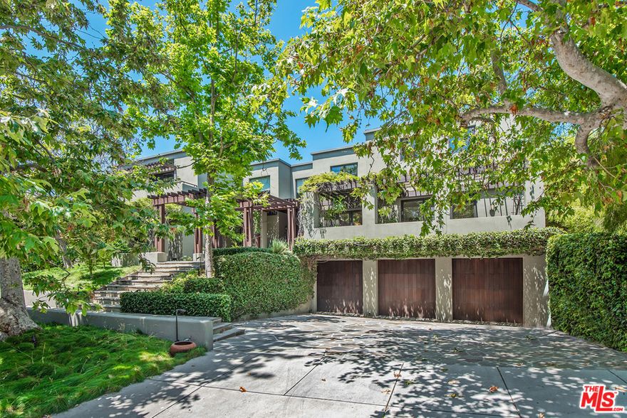 Stunning contemporary home in the exclusive Palisades Riviera.  Built in 2003 and set above the street among gorgeous sycamores, this private and serene house has 6 bedrooms, 9 baths, and an open floor plan that provides a comfortable California living experience.  A delightful water feature graces the front entry, which leads to a formal dining room, living room, gourmet kitchen with soaring ceilings, and family room.  Also on the main floor are two en suite bedrooms, an office, and a laundry room. The second floor has four en suite bedrooms, including a spacious master wing with a sitting area, luxurious bath, his and her closets, and a balcony with ocean views. The lower level features a home theater, massage room, and 3-car garage.  Enjoy the large, grassy backyard, beautiful pool and spa, BBQ, and vine-covered patios ideal for al fresco dining.  Situated on a 15,616 square foot lot, this property feels like a private resort.