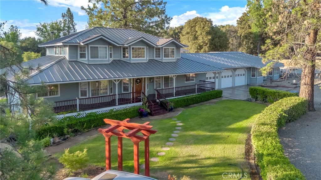 Welcome to 50711 Road 426, Oakhurst - A True Mountain Retreat!
Set on 3.99 acres, this beautifully landscaped custom home offers privacy, space, and flexibility. The main residence features 3 bedrooms, 2.5 bathrooms, a home office (or optional 4th bedroom), and a 3-car garage. Attached but separate guest quarters include 2 bedrooms, 1.5 bathrooms, a full kitchen, private entrance, and a sunroom that can serve as a 3rd bedroom perfect for extended family or potential rental income.
Inside, enjoy coffered ceilings, hardwood floors, a living room with freestanding wood stove, formal dining room, and a chef's kitchen with granite counters, center island, and breakfast nook. The main level offers a bedroom and full bath, with the primary suite, two additional bedrooms, and another full bath upstairs.
Exterior highlights include covered porches, garden, greenhouse, barn, sheds, woodshed, fenced horse setup, and an approx. 24' x 60' RV building for storage. A separate, permitted 2-story structurewith an attached carport ideal for workspaceadds flexible use for hobbies, a gym, or studio. Just minutes from townthis is mountain living at its best!