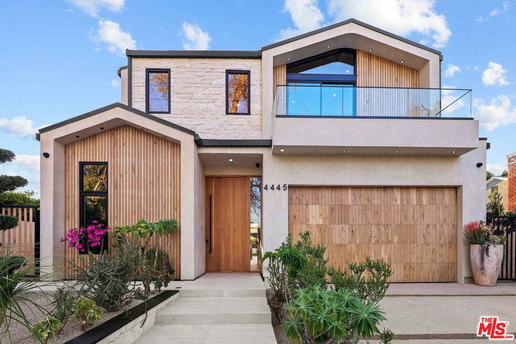 Tucked in the heart of Studio City, this newly built modern farmhouse blends sleek sophistication with natural warmth. Featuring 4 beds and 5 baths in the main house plus a 1 bed/1 bath ADU, the property is designed for both luxury and livability. The main level opens with soaring ceilings, cove lighting, and wide-plank oak floors. A wall of floor-to-ceiling sliders floods the space with light and creates a seamless flow to the outdoor retreat complete with pool, spa, outdoor kitchen, and a private grassy lawn surrounded by lush hedging. The gourmet kitchen is a showpiece, with custom oak cabinetry, LED-lit smoked glass shelving, and built-in Miele appliances including a double oven, coffee machine, oversized fridge/freezer, and hidden exhaust above a 6-burner stovetop. The oversized island invites gathering and effortless entertaining. Upstairs, the vaulted primary suite features wood-paneled ceilings, a fireplace, a private terrace, a spa bath, and a custom walk-in closet. Two more en-suite bedrooms and a full laundry room complete the upper floor. Downstairs, an additional en-suite bedroom offers flexibility for guests, a home office, or gym. The detached ADU mirrors the home's architectural warmth, with pitched ceilings, sliding doors, and its own full kitchen ready to become whatever you need it to be: a guest retreat, a poolside escape, a creative studio, or your ultimate entertaining space. Every inch of this home was crafted with intention refined, functional, and built to inspire.