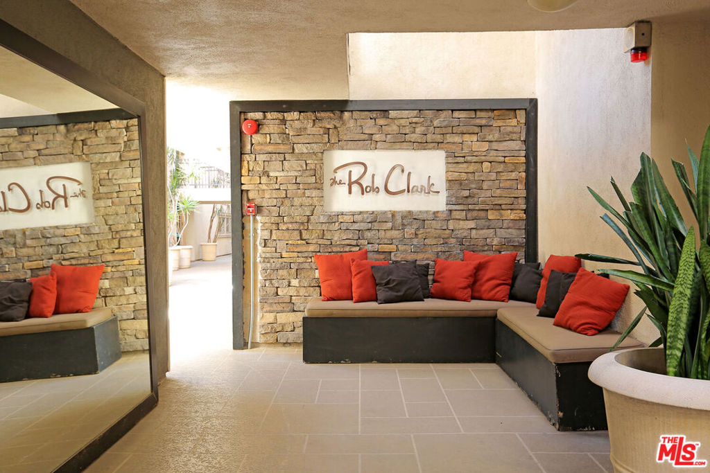 Fabulous location!! This one bedroom unit comes with 2 parking spaces! 1Bedroom + 1Full Bath +Den Condo with private balcony. Spacious bedroom connected to a walk-in closet with custom shelving. Multi-function den can be used as dining room, office and more. Adorable corner balconette. Living room with fireplace. Kitchen features large counter top with white cabinets and stainless appliances. In-unit laundry and onsite laundry room near the gallery-style lobby. Newly updated with fresh paint. Community offers fitness room and sparkling pool in the courtyard. Gated front entrance to building. Highly desirable location close to Cedars Sinai and restaurant/shop favorites.