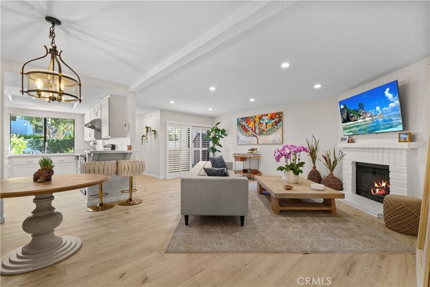 Welcome to Warner Club Villas, a beautifully maintained community in the heart of Woodland Hills. This spacious multi-level townhome blends thoughtful updates with warm, inviting charm. Enter through your private two-car garage on the lower level, then head upstairs to the main living area—a bright, open-concept space with wide-plank flooring, recessed lighting, plantation shutters, and a cozy white brick fireplace. The remodeled kitchen offers quartz countertops, shaker-style cabinetry, stainless steel appliances, and a garden window overlooking lush greenery.

A private patio extends your living space outdoors, perfect for morning coffee or evening gatherings. On the next level, you’ll find a secondary bedroom, updated bathroom, and a versatile loft that has been enclosed with a wall and door, creating a more private room option—ideal for a home office, guest room, or nursery. The top floor primary suite features vaulted ceilings, a second fireplace, dual closets, and a refreshed ensuite with double vanities.

Enjoy resort-style amenities including a pool, spa, and tennis courts—all just moments from The Village, Westfield Topanga, parks, and freeway access. A rare opportunity to own a turnkey home with a flexible enclosed loft layout not commonly found in this community.
