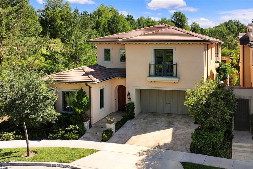 Welcome to 51 Thoroughbred, a stunning newer-construction end-unit home located on a private cul-de-sac in the desirable Strada community of Orchard Hills. This residence boasts soaring cathedral ceilings and an open floor plan, creating a bright and inviting living space. Expansive glass doors and windows open to a beautifully landscaped backyard featuring travertine flooring, a water feature, and a built-in BBQ island with seating—perfect for outdoor entertaining. The interior has been upgraded with brand-new flooring throughout, complementing the gourmet kitchen with custom tile backsplash, a large center island with seating, KitchenAid appliances, ceiling-height cabinetry, and a walk-in pantry. A convenient downstairs bedroom and full bath are ideal for guests or multi-generational living. Upstairs, a versatile loft offers space for a playroom, office, or media room. The serene primary suite includes a customized walk-in closet and spa-inspired bath with dual vanities, a soaking tub, and a separate shower. Two additional bedrooms, a full bath with double sinks, and a spacious laundry room complete the upper level. Additional highlights include a reverse-osmosis water filtration system, whole-house water softener, plantation shutters, automatic outdoor lighting and irrigation, and a garage with epoxy flooring and extensive built-in cabinetry. Residents of Orchard Hills enjoy resort-style amenities including pools, spas, BBQ areas, basketball courts, and playgrounds. Conveniently located near major freeways, toll roads, premier shopping and dining, and within the award-winning Irvine Unified School District including Northwood High School.