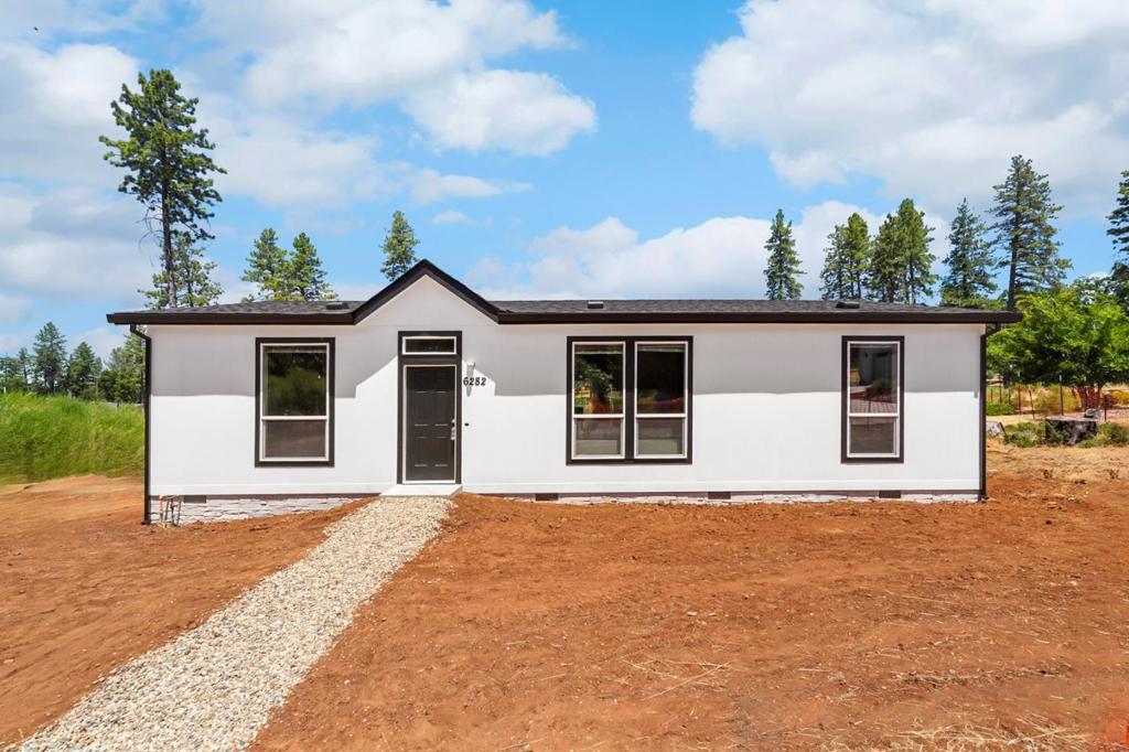 Seller willing to consider rate buy down or owner's financing. In a quiet cul-de-sac with flowered trees and lots of green, you will find this stunning manufactured home featuring soaring 9-foot ceilings and a bright, open floor plan. The seamless layout that effortlessly connects the living, dining, and kitchen areas is perfect for entertaining or everyday living. The private primary bedroom is thoughtfully set apart from the other rooms, offering a quiet retreat with a walk-in closet. Enjoy the convenience of a dedicated mudroom, ideal for keeping your home tidy and organized. The home is designed with modern touches and future-ready features, including central AC and pre-wiring for ceiling fans. Bonus: equipped with sprinklers! Step outside to the magical backyard, a blank canvas with infinite possibilities. Combining contemporary design with functional elegance, this home offers exceptional value and lifestyle flexibility. Desirable features: Sprinklers 9' Flat Ceilings Durabuilt Cabinetry with Satin Silver Hardware Recessed LED lighting Energy Energy Star Certified (2024 v2.0) R40 Ceiling / R21 Walls / R38 Floor Insulation 95%EFU High Efficiency Gas Furnace with insulated ducts Low-E dual-glazed vinyl windows, fire safety tempered. 200 AMP electrical panel