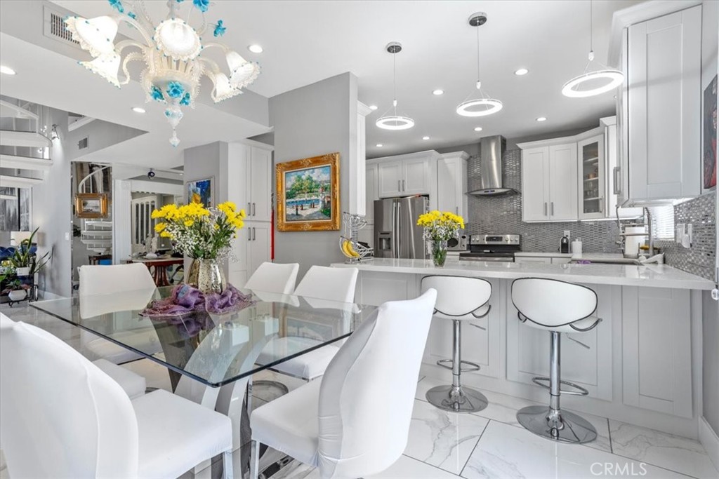 Introducing a completely remodeled 2-bed/2-bath top floor penthouse end unit condo with nearly 2,000 sq ft of impeccably designed living space! Tucked inside a resort-style community in Encino, this updated stunner is the ultimate entertainer paradise.
Step into a pristine open floorplan living room with soaring 20-foot ceilings,abundant natural light, fireplace, and a seamless indoor/outdoor flow. The stunning kitchen is outfitted with stainless steel appliances adjacent to a spacious dining area . With in unit washer/dryer, recessed lighting, two balconies, upstairs loft, AND private rooftop deck.... this ideal property is the definition of everyday convenience and versatility.
The primary bedroom features a large walk-in closet, private balcony, dual vanity sinks, and modern shower with waterfall showerheads.
The upstairs loft is suitable for an extra bedroom or private office space. Adjacent to the loft is a private rooftop deck with breathtaking mountain views of Los Angeles — your personal slice of SoCal paradise.
Additional amenities at the Encino Spa South Community include a sparkling pool, jacuzzi, sauna, fitness center, and a tranquil courtyard—all just footsteps away from Ventura Blvd, the 101 freeway, and some of Encino’s best shopping and dining. HOA covers earthquake insurance, water and trash.
Unit also provides FOUR PARKING SPACES inside the garage, in addition to plenty of guest parking also.
Don’t miss this rare blend of size, style, and location in a beautiful neighborhood of Encino!