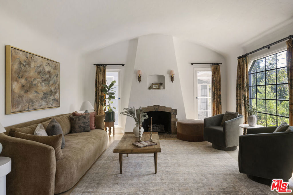Welcome to this charismatic 1930's Highland Park Tudor, situated squarely between some of the city's most beloved restaurants, bars and coffee shops along York Blvd and Figueroa Street. A well-appointed layout and high, barrel-vaulted ceilings makes this 3 bed, 2 bath gem feel expansive. French casement windows, an architecturally stunning plaster fireplace and lovely natural lighting offer authentic charm. A beautiful arch detail frames the large dining room. A bright kitchen is fashioned with inset wood cabinetry and stone counters. The primary bedroom features an en-suite bathroom with a double vanity. French doors open to flagstone patios from both back bedrooms. A detached 1 bedroom, 1 bathroom ADU sits at the top of the long driveway and is perfect for guests, extended family or extra income. A sparkling cowboy pool completes the large, tranquil backyard setting. Lovely moments are all around in this well cared for home. This special property in the heart of NELA is your own quiet, private oasis and ready to be your forever home.
