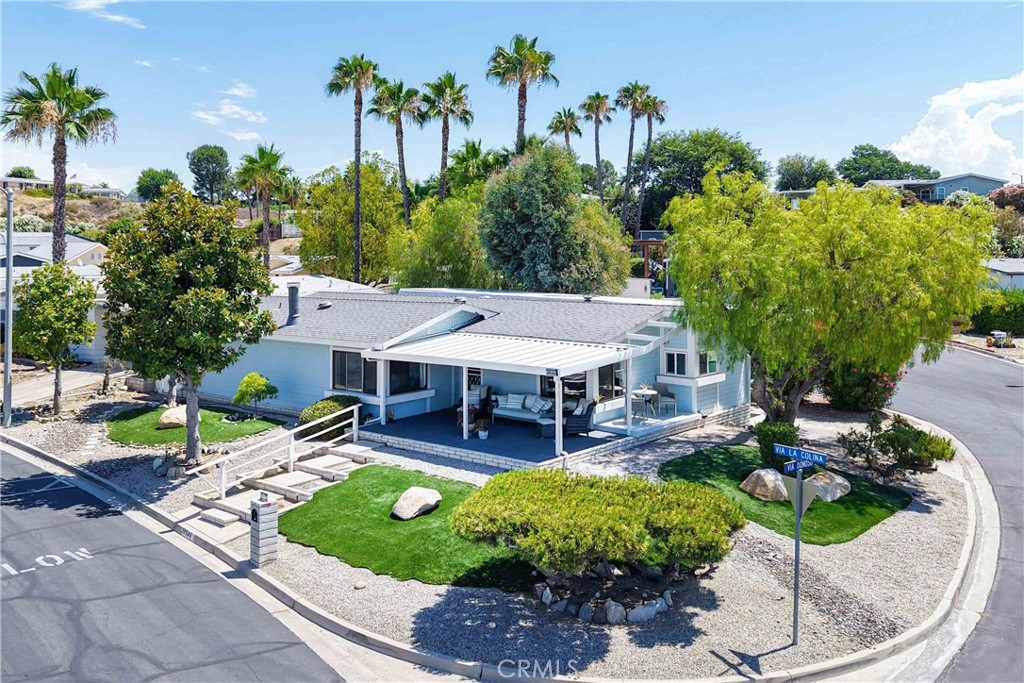 Views! Views! Views! You OWN the Land – No Space Rent and 433 certified so it is financeable! Welcome to one of the most desirable homes in this vibrant 55+ community! This rare triple-wide sits on an elevated corner lot at the end of a quiet court, offering privacy with no direct neighbors and sweeping views from nearly every room. Enjoy the peace and beauty of sunrises from the front porch and breathtaking sunsets from your living room, kitchen, and dining area. This home is thoughtfully positioned so you're never looking into a neighbor’s window or rooftop—just open sky and nature. Features You'll Love, just to name a few: Spacious open floor plan filled with natural light, RV parking with sewer dump, low-maintenance landscaping with mature trees, AstroTurf, and a cozy pergola with solar lighting, two sheds, extra parking, and room to build a garage while keeping RV space. This home features Stunning Upgrades Throughout including a brand new roof, new luxury flooring with black floor register covers, all-new kitchen with shaker cabinets, quartz counters, subway tile backsplash, deep stainless sink, touchless faucet, pull-out pantry shelves, lazy Susan, and stainless steel appliances, new bathrooms with updated vanities, toilets, mirrors, and fixtures, keyless entry locks, matte black hardware, new porch lights, doorbell, and solar house numbers. This is more than just a home—it’s a lifestyle! Bring your golf cart and enjoy the fun, active community with a variety of amenities and activities. Whether you're relaxing on the porch, enjoying the views, or entertaining friends under the pergola—this home has it all. Don’t miss this rare opportunity to own a triple-wide with unmatched views, land ownership, and room to grow. The possibilities are endless!