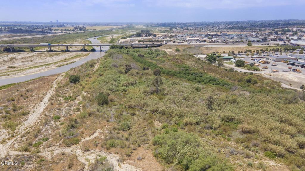 This 14.44-acre property in Saticoy, encompassing two APNs, presents a unique opportunity. While a portion of the land extends into the river, preliminary verbal information from an engineer indicates that several acres may be suitable for development as a storage yard. Be advised that there are currently no utilities on the property, and the sale does NOT include any water rights or shares. All interested parties are advised to conduct their own due diligence by verifying all information with their engineers and exploring potential land uses with the County of Ventura.