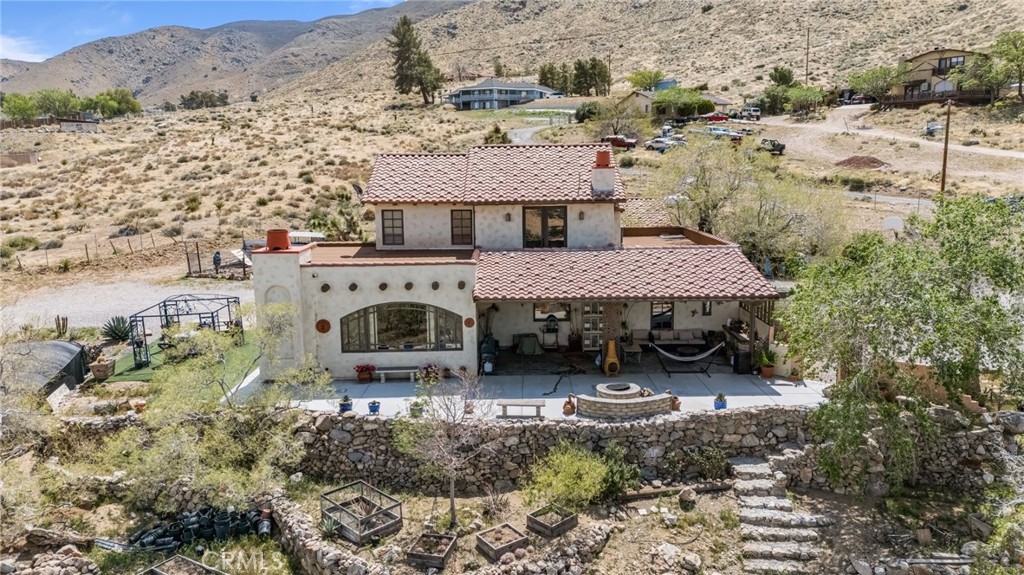 Authentic Hacienda Elegance with Modern Flexibility in Mariana Highlands
Nestled in the prestigious Mariana Highlands of Apple Valley, this exceptional Hacienda-style estate blends timeless architecture with modern-day versatility. Boasting 4 spacious bedrooms, 3 full bathrooms, and over 3,000 sq ft of thoughtfully designed living space, this 3,031 sq ft home sits on a generous 56,628 sq ft lot with commanding desert views and serene privacy.
From the moment you enter, you're greeted by soaring ceilings, hand-crafted arched passageways, stained alder wood accents, and imported Mexican tile that echo the charm of traditional Hacienda design. A cozy yet elegant fireplace anchors the main living area, offering the perfect backdrop for intimate gatherings or quiet evenings at home.
The versatile 4th bedroom features a private entrance and ensuite bath—ideal for a guest suite, home office, creative studio, or multigenerational living setup.
Step outside to experience the ultimate in indoor-outdoor living. Expansive patios, peaceful courtyards, and panoramic views of the valley make this home an entertainer’s dream. The oversized 4-car garage provides ample room for car enthusiasts, storage, or a workshop.
This property is not just a home—it’s a lifestyle. A rare opportunity to own a true desert gem that exudes warmth, craftsmanship, and sophisticated Southwest charm.