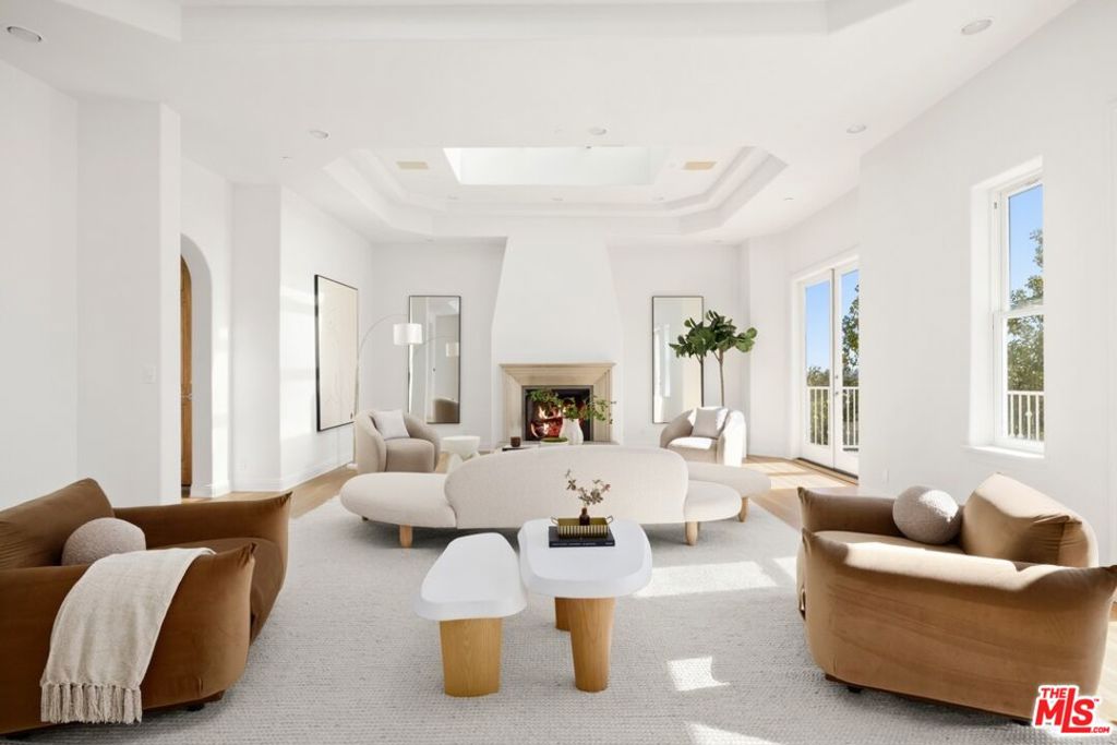 Step into timeless elegance in this beautifully furnished Bel Air residence, ideal for both families and discerning individuals. With grand scale and thoughtful design, the home features soaring ceilings, abundant natural light from skylights, and oversized living spaces, including formal living and dining rooms, a spacious family room, and a true chef's kitchen.The home offers six generous bedrooms, including a luxurious primary suite with dual spa-like bathrooms and expansive walk-in closets. Children's en-suite bedrooms provide comfort and privacy, while two additional self-contained guest suites, each with its own living area and kitchenette, offer exceptional accommodations for long-term guests or extended family. Every detail has been considered: custom built-ins, a private library, wine storage, multiple wet bars, a gym, sauna, and a resort-style backyard with a pool, spa, gazebo, and al fresco dining area. French doors open to private balconies that frame sweeping canyon, city, and ocean views.A rare and dazzling offering in one of LA's most prestigious enclaves.