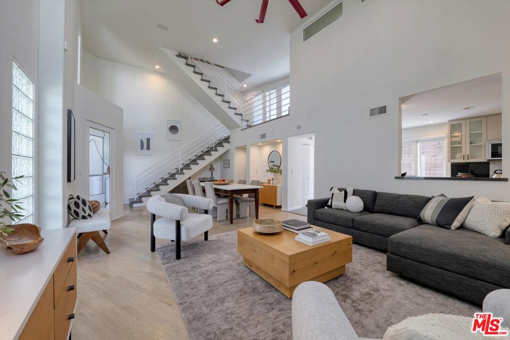 Highly sought after large three bedrooms, three bathrooms, plus loft (can be used as a fourth bedroom), townhome just a half block from Montana Avenue shopping and restaurants. A light and bright end unit freshly painted with an abundance of outdoor space including a large southwest facing rooftop terrace. Impressive 20 foot ceilings on the mail level make for a grand living/dining space for entertaining. The kitchen features high-end stainless-steel appliances, marble countertops, a pantry, recessed lighting, and a generous sized private outdoor area conveniently located adjacent to the kitchen. Ascending to the loft area, you have a fully enclosed bonus room with custom built-in's ideal for a studio, office or fourth bedroom. Primary bedroom en-suite includes walk-in closet with organizers, double vanity sinks, large walk-in shower, towel warmer rack, make up table and additional linen cabinetry. Washer dryer side-by-side, conveniently located on second floor near bedrooms. Some special details of this lovely home include double pane windows, dual zone heating and air conditioning, hardwood floors, recessed lighting, custom roller shade window coverings, plantation shutters, and three outdoor areas. In addition, there's a functional basement with storage built-in cabinetry, two car, direct access, private garage and large adjacent storage room. Homeowner amenities include earthquake insurance, lush landscaping, guest parking, gated and secure building in Franklin and Lincoln school neighborhood. This is a must see in person home, to feel how impressive and unique it truly is!