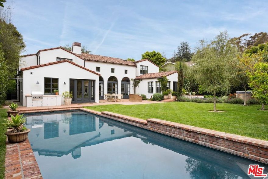 Exceptional design and an unbeatable location in the heart of Rustic Canyon. Nestled on a prime street, this sun-filled custom residence exudes warmth and sophistication. Built by Morrow & Morrow and designed by Steve Gianetti, this home features soaring ceilings, natural textures, a soothing color scheme and an intentional layout that flows seamlessly into serene outdoor living areas. Native landscaping harmonizes with the home's architecture and the surrounding canyon. The main floor showcases a striking living and dining space, a tucked-away office for quiet work, a cozy eat-in kitchen, a spacious mudroom with direct access to the two-car garage, and a separate guest room with its own private entry. A few steps above, the secluded primary suite opens out to a lush lawn, pool and a tranquil path leading to a private cedar soaking tub. Upstairs offers flexibility with up to four additional bedrooms, two of which have been converted to an additional office and media room. A broad, light-filled hallway overlooks the main level and connects to a romantic balcony with views of the front garden. Crafted with exquisite finishes and interiors by Nickey Kehoe, this home delivers incredible ambiance while still being conveniently located near the best of the Westside and top-rated schools. A rare chance to own a property that combines elegance, location and architectural integrity. Access via Sunset now available.
