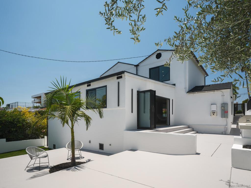 Experience elevated modern living in the heart of Mission Hills at this one-of-a-kind, fully reimagined residence. Encompassing 4 bedrooms, 3.5 bathrooms, and over 3,200 square feet of thoughtfully curated living space, this architectural showpiece has undergone a complete transformation with over $400,000 in bespoke upgrades. From the moment you arrive, the striking facade sets the tone with smooth stucco, a glass-framed balcony, and a white oak pivot entry door flanked by a designer glass garage. Inside, sophisticated textures and premium finishes abound—luxury vinyl plank flooring, Taj Mahal quartzite countertops, custom Euro cabinetry, and floor-to-ceiling tile work lend an air of refined elegance. The open-concept floor plan effortlessly connects the kitchen, living, and multiple lounge areas, offering both volume and intimacy for everyday life and entertaining. A dramatic 16-foot bifold door opens to the private outdoor retreat, complete with built-in BBQ and curated landscaping for seamless indoor-outdoor living. The spa-inspired primary bath features a sculptural freestanding tub, dual vanities, and gold accents that exude quiet luxury. Every detail has been considered, from the custom wine cellar and glass staircase to the fully integrated smart lighting and HVAC systems. Situated in one of San Diego’s most desirable neighborhoods, this turnkey masterpiece blends high design with timeless comfort—just moments from top dining, shopping, and coastal access.