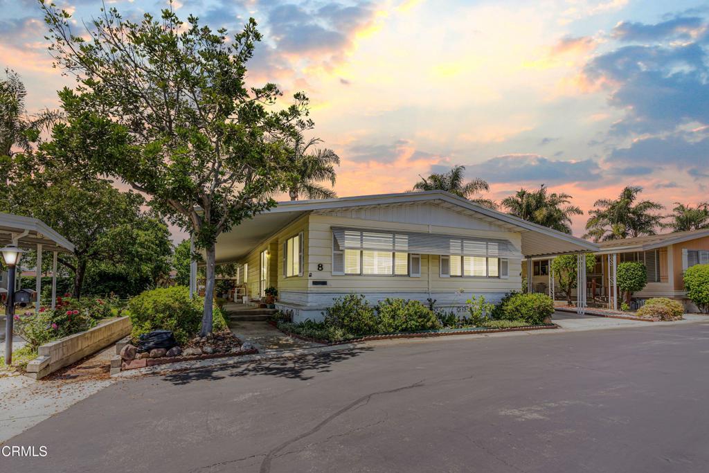 Welcome to this beautifully maintained 2-bedroom, 2-bath home nestled in a serene 55+ community in Camarillo. Offering 1,440 sq ft of comfortable living space on a 4,438 sq ft lot, this delightful residence blends warmth, functionality, and charm throughout.Enjoy tranquil evenings on the inviting front porch, the perfect spot to unwind and take in the quiet surroundings. Inside, you're welcomed by a bright and airy living room, featuring plush carpeting and large windows that bathe the space in natural light.Just off the living room, the dining area flows seamlessly into a well-appointed kitchen with tile flooring, generous cabinetry for all your storage needs, and quality appliances--ideal for everyday cooking or hosting guests. A cozy adjacent family area provides even more room to relax, read, or entertain.The guest bedroom offers convenient access to a full hallway bath, while the spacious primary suite is a true retreat, complete with a private en-suite featuring dual sinks and a luxurious soaking tub.Additional highlights include a covered carport with room for two vehicles and low-maintenance landscaping.With its prime location and comfortable layout, this home is the perfect blend of convenience and easy living in one of Camarillo's most sought-after 55+ communities.