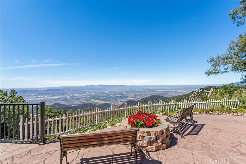 Spectacular Panoramic Views – Level Entry Mountain Retreat! Perched above the clouds with breathtaking views from Mt. San Gorgonio to the Pacific Ocean, on clear days you can see Catalina Island and the LA downtown skyline. This exceptional 5-bedroom, 4-bathroom home offers the rare combination of level entry, privacy, and stunning scenery. Adjoining the National Forest, this home is like living on the rim of the world!
The main level features an open-concept design with soaring vaulted ceilings in the living and dining areas, seamlessly flowing into a spacious, updated custom kitchen with granite countertops, and center island. On the upper level, there are en-suite bedrooms offering comfort and flexibility for family and guests. In addition, this home features an abundance of thoughtfully designed storage.
Enjoy the expansive flat backyard, ideal for entertaining or relaxing while taking in city lights and coastal sunsets. Additional highlights include, two family rooms, home office, RV parking, a 2-car attached garage, and ample guest parking. Come experience life in the mountains in this quiet, sought-after neighborhood. Total sq footage includes finished basement. This one-of-a-kind property is a true mountain gem.