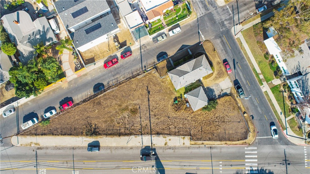 Introducing two contiguous parcels comprising a unique 14,493-square-foot triangular lot with unmatched potential, situated on high-traffic Anaheim Street with frontage on all three sides. This exceptional property is strategically positioned for maximum visibility, making it perfect for commercial development or mixed-use projects. Passed down through generations, it is now being offered on the market for the very first time, presenting a truly unique opportunity. Currently, the lot features a duplex with two one-bedroom units and a two-car garage, offering immediate rental income while you plan your next move. Utilities are already on site to streamline the development process, adding convenience for future projects. Zoned LAC1.5, this property provides the flexibility for a variety of commercial and residential uses, aligning perfectly with the dynamic needs of the area. Situated in a bustling corridor surrounded by thriving businesses and vibrant residential communities, this location benefits from consistent vehicle traffic. Proximity to retail, dining, and public transit further enhances its appeal, making it an attractive destination for future tenants or customers. With its high traffic count and strategic location, this lot is a rare find, offering both significant development possibilities and unparalleled accessibility. Don’t miss this opportunity to transform a prime piece of real estate into a thriving enterprise.