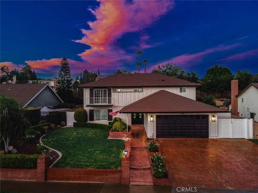 Welcome to Buttonwood Drive, where timeless design meets modern living in one of Brea’s most sought-after neighborhoods. This beautifully remodeled residence offers the perfect blend of sophistication, comfort, and lifestyle — setting the stage for your next chapter. Step through the front door and you’re immediately greeted by a grand entry with sweeping staircase, sparkling chandelier, and elegant powder room. Wide-plank luxury vinyl flooring in a warm post-oak finish carries throughout the home, creating seamless flow and refined style. The living and dining rooms open gracefully to one another, framed by recessed lighting and a cozy fireplace — perfect for gatherings large or small. At the heart of the home, a reimagined kitchen shines with quartz countertops, GE Café appliances, and a walk-in pantry that glows like a hidden treasure. The open concept connects effortlessly to the spacious family room, where a custom entertainer’s bar invites laughter, conversation, and endless celebration. Slide open the doors and let the party spill outdoors — to a backyard oasis with a massive, covered patio, outdoor bar, surround sound, heaters, ceiling fans, gas fireplace, BBQ, turf play area, and even a dedicated dog run. It’s your personal resort, designed for year-round fun. Upstairs, the private primary suite offers a retreat with double closets and elegant finishes. Additional bedrooms provide flexibility, including an expanded room created by opening a wall — easily converted back to a 5-bedroom layout to suit your needs. Bathrooms sparkle with quartz, marble, and designer fixtures, while modern upgrades — Nest thermostat, whole-house fan, upgraded AC/furnace, new water heater, smart lighting, keyless entry, Ring cameras, and an upgraded electrical panel — deliver both comfort and peace of mind. Beyond the home, the lifestyle is unmatched. Top-rated schools like Falcon Elementary, Brea Junior High, and Brea Olinda High are nearby. Downtown Brea offers dining at Our Nest, Reunion, or Old Brea Chop House, plus shopping at Brea Mall and entertainment at Birch Hills Golf Course and Craig Regional Park. And in under 30 minutes, you’re at Disneyland, Angel Stadium, Honda Center, or the beaches of Orange County. Buttonwood Drive isn’t just a home. It’s where style meets substance, where memories are made, and where life is meant to be enjoyed. Welcome home.