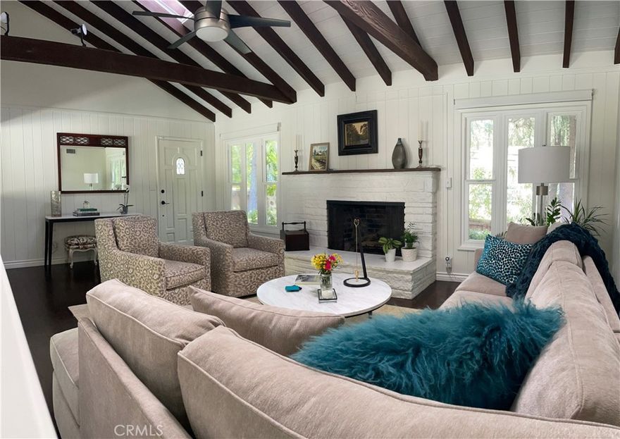 Welcome to your resort-style oasis—Home Sweet Home! This beautifully remodeled custom ranch-style residence, set on an expansive 26,000+ sq. ft. lot, total of  2846 sq. ft of living space, offers the perfect blend of luxury, comfort, and serenity in one of the area's most sought-after neighborhoods. From the moment you arrive, the professional landscaping and meticulous attention to detail invite you into a lifestyle of relaxed elegance. Inside, the heart of the home is a stunning high-end kitchen featuring top-of-the-line finishes, including a Wolf stovetop, stone countertops, beautifully crafted cabinetry, an island with seating, a charming breakfast nook, and a built-in desk area—all enhanced by timeless brick accents. This lovely home showcases warm wood flooring and dramatic vaulted beam ceilings in the great room, dining area, and primary suite, creating an atmosphere of spaciousness and style. The great room centers around a cozy fireplace, with skylights bathing the space in natural light. The luxurious primary suite offers direct access to the backyard, a spa-like bathroom, and a generous walk-in closet, while the additional bedrooms are nicely sized—one offering flexible use as a den or office. A thoughtfully designed extra-large laundry room with built-in home office space ensures functionality for modern living. Outside, the resort-style backyard is a private paradise, featuring a sparkling pool with a lighted fountain, multiple Zen-inspired sitting areas, a covered patio perfect for al fresco dining, and lush gardens including irrigated raised beds, fruit trees, and a thriving orchard. The attached two-car garage provides ample storage, and the property’s location within the coveted Wilbur Elementary, Portola Middle, and Taft High School districts offers exceptional educational opportunities. With nearby hiking trails, exquisite craftsmanship, and unmatched tranquility, this home is the ultimate indoor-outdoor sanctuary—an ideal place to unwind, entertain, and truly feel at home. You will be impressed by the quality and condition of this home. Schedule your private showing today!