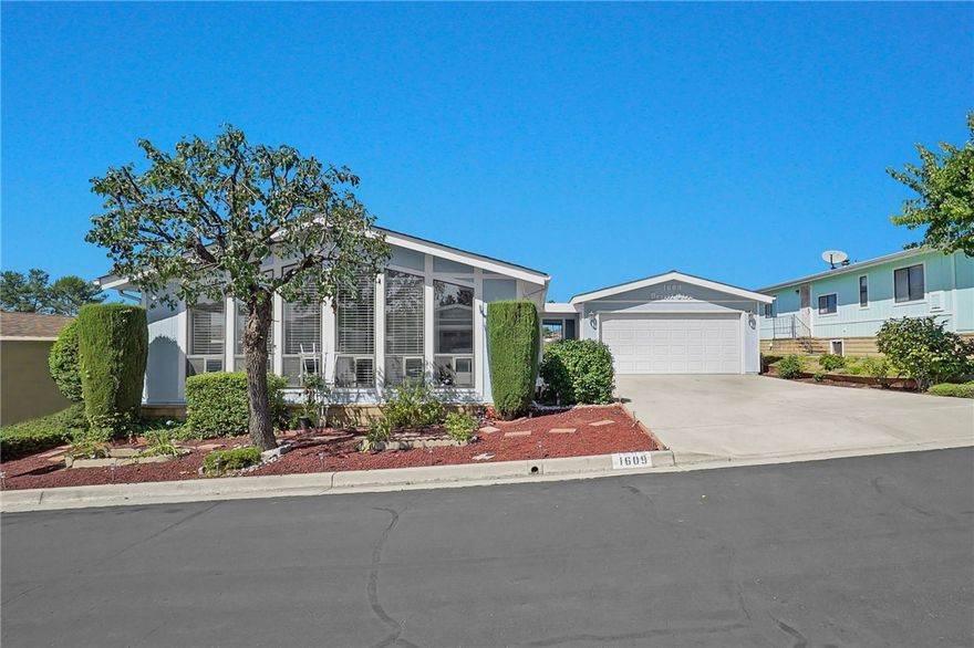 This beautifully restored 2-bedroom, 2-bath manufactured home with a rare 2-car garage offers modern comfort, thoughtful upgrades, and a vibrant lifestyle. Nestled in a well-maintained senior community that radiates pride of ownership, this home is move-in ready with plenty of charm and functionality.

Step inside to discover a spacious, remodeled kitchen featuring stunning granite countertops, natural wood cabinetry, and wood-look tile floors—perfect for cooking and entertaining. The large dining room flows effortlessly into the inviting living area with high-quality laminate flooring, ideal for everyday living or hosting guests.

Both bathrooms have been tastefully updated with granite countertops, tile flooring, and modern fixtures. The master suite includes dual sinks, a beautifully tiled walk-in shower and tub, and a generous walk-in closet. Both bedrooms offer upgraded carpeting and ample space for comfort and relaxation.

Additional highlights include:

• Energy-efficient Anlin dual-pane windows (south-facing)

• Recently replaced AC unit

• Spacious laundry room with extra storage and room for a freezer

• Lovely landscaped yard with a covered patio, perfect for enjoying beautiful evening sunsets

• Fruit trees and garden space including orange, lemon, roses, and a mature grapevine

Enjoy the perks of a low HOA that includes trash service and basic Cox cable. The active community features a clubhouse with a commercial kitchen, large gathering spaces, library, billiards room, heated pool, spa, shuffleboard, BBQ area, and shaded seating. A fitness center and additional meeting rooms are just across the street.

This is more than a home—it’s a lifestyle. Schedule your private showing today!