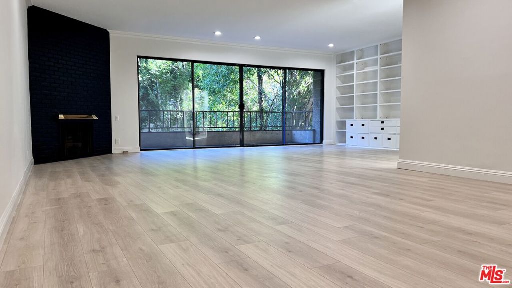 This beautifully remodeled unit boasts over 2400 sqft of living space, surrounded by verdant greenbelt views. Light drenched with Eastern and Southern exposures, it features hardwood floors, fireplace, recessed lighting as well as Miele washer and dryer in the unit! A gracious entry foyer opens to an expansive L shaped living and dining area with walls of glass to the balcony. The chef's kitchen features a breakfast area and top of the line stainless steel appliances throughout. The extraordinary primary suite is huge with a sitting area, an extra-large walk-in closet and a modern bath with spa tub and shower. There are also 2 side by side parking spaces, a swimmers pool and spa plus an expansive lobby!