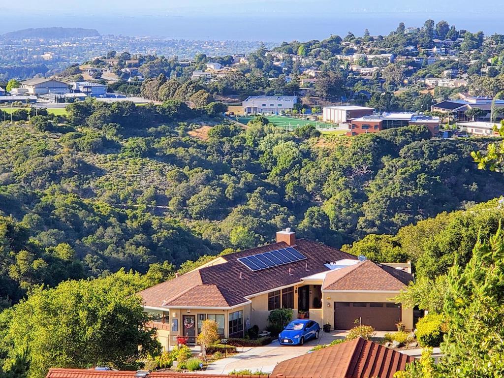 OFFER DATE: Aug 12th Tuesday 5 PM Welcome to this CUSTOM BUILT (in 2013) spacious 5-bedroom plus OFFICE, 4.5 bath home located in the beautiful city of Belmont with a stunning view of the Bay, San Francisco, Oakland, Hayward & has a LARGE SIDE YARD! This stunning property spans 3040 square feet & is situated on a VERY GENEROUS 22,434 square foot lots (2 parcel). Features a modern kitchen equipped with gas cooktop, granite countertops, built-in oven, and a large island. Among its many amenities, you'll find vaulted ceiling, & a walk-in closet, OFFICE, CCTV Security & FIRE SPRINKLER. Flooring throughout consists of elegant bamboo hardwood & durable tile. Cozy up in front of the fireplace in the separate great room or relax in your own STEAM SHOWER room. Has a laundry room with washer, dryer and ample utility space. Located with the Belmont-Redwood Shores School District. This home is ideal for families seeking HIGH QUALITY public education. Additional perks include central forced air heating (DUAL ZONED) with ceiling fans all over for cooling & energy-efficient features liked OWNED SOLAR & BACK UP BATTERY, dual pane windows & a TANKLESS water heater. Plus, the home is prepped for electric vehicle hook-ups (240 Volts Level 2) & offers a 2-car garage.