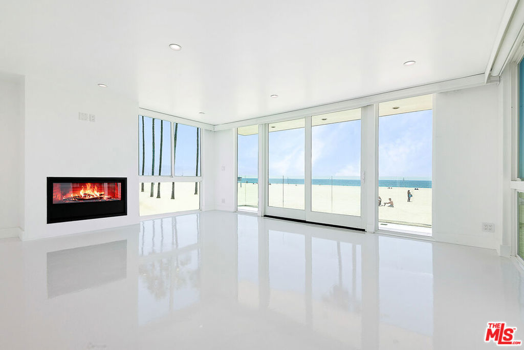 ICONIC VENICE BEACHFRONT PENTHOUSE WITH BREATHTAKING PANORAMIC VIEWS Soaring above the shoreline in one of Venice's most coveted oceanfront locations, this exceptional 3Bdrm, 3Bath penthouse offers unobstructed, wraparound views of the Pacific Ocean, golden sunsets & the vibrant coastline necklace. This rare offering features dual kitchens, a sun-drenched private patio, balconies, two elegant fireplaces, blending sophisticated design with beachside comfort. With expansive open-concept living spaces, floor-to-ceiling windows, and an abundance of natural light, the residence invites seamless indoor-outdoor living & the ultimate in relaxation and entertaining. Additional highlights include: *Direct-access 2-car private garage (additional parking available), *State-of-the-art security system throughout *High ceilings, *Spa-inspired bathrooms, *Generous storage space, *Separate Guest Suite ideal for Guests, Private Office, Creative Space, or multi-generational living Located on the sand, this stunning penthouse places you in the heart of Venice Beach culture moments from premier restaurants, the Venice Canals, Muscle Beach, the Volleyball Academy, Abbot Kinney, & both the Santa Monica and Washington Piers. A once-in-a-lifetime opportunity to live in a true architectural Trophy property with one of the most iconic soaring coastal ocean views in all of Los Angeles.