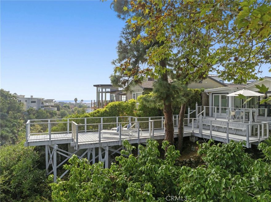 Recently remodeled and offered fully furnished, this stunning single level 2-bedroom plus office, 1.5-bath coastal retreat blends modern design with effortless comfort. Vaulted ceilings, skylights, and expansive windows fill the home with natural light and frame picturesque ocean and gully views. Each bedroom accommodates a queen-size bed, while a charming office nook captures tranquil coastal scenery. The spacious back deck invites outdoor dining and lounging, where sweeping ocean vistas set the stage for memorable sunsets. Inside, the fully renovated kitchen impresses with quartz countertops, island with breakfast bar, and stunning backsplash; Thermador stainless steel appliance suite; stainless drawer microwave, range hood, and farmhouse sink with designer fixtures. Abundant white shaker cabinetry, solid white oak open shelving, and a custom dining banquette with built-in outlets complement the coastal aesthetic, paired beautifully with a McGuire dining set. Additional highlights include wide-plank LVP flooring, new HVAC with central A/C, inline water heater (installed October 2025), and updated bath vanities and fixtures. Remote-control window shades, fresh interior paint, and thoughtful tech additions. With a sofa bed in the den, second refrigerator and storage in the garage, and ample street parking, this home offers both flexibility and convenience. Every detail, from linens to kitchenware, has been curated for comfort and style. A true coastal haven, showcasing exceptional craftsmanship, modern elegance, and views throughout.