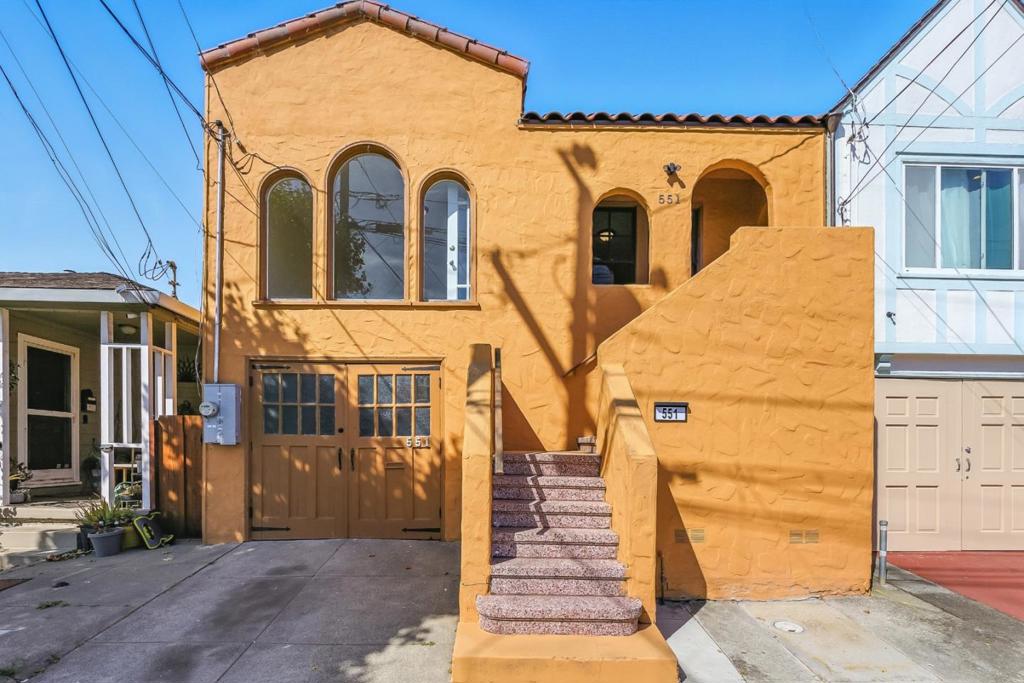 Step into the warmth and character of this 1930s Spanish Revival style home at 551 Green Avenue. With 2 bedrooms, 1 bathroom, and approximately 840 sq. ft. of inviting living space, this home offers a perfect blend of comfort and possibility. Freshly painted upper-level interior and cozy carpet (installed July 2025) create a welcoming atmosphere, while the light-filled living area invites you to relax and make memories. The kitchen and bathroom are ready for your personal touch and remodeling vision, offering the chance to design spaces that truly reflect your style. Outside, a beautiful deck overlooks a level yard, perfect for gardening, play, or entertaining. The lower level, complete with single car garage, offers additional potential for expansion or creative use. Ideally located near downtown San Bruno, major commute corridors, shopping, dining, and top employment centers, this home is as convenient as it is full of opportunity.