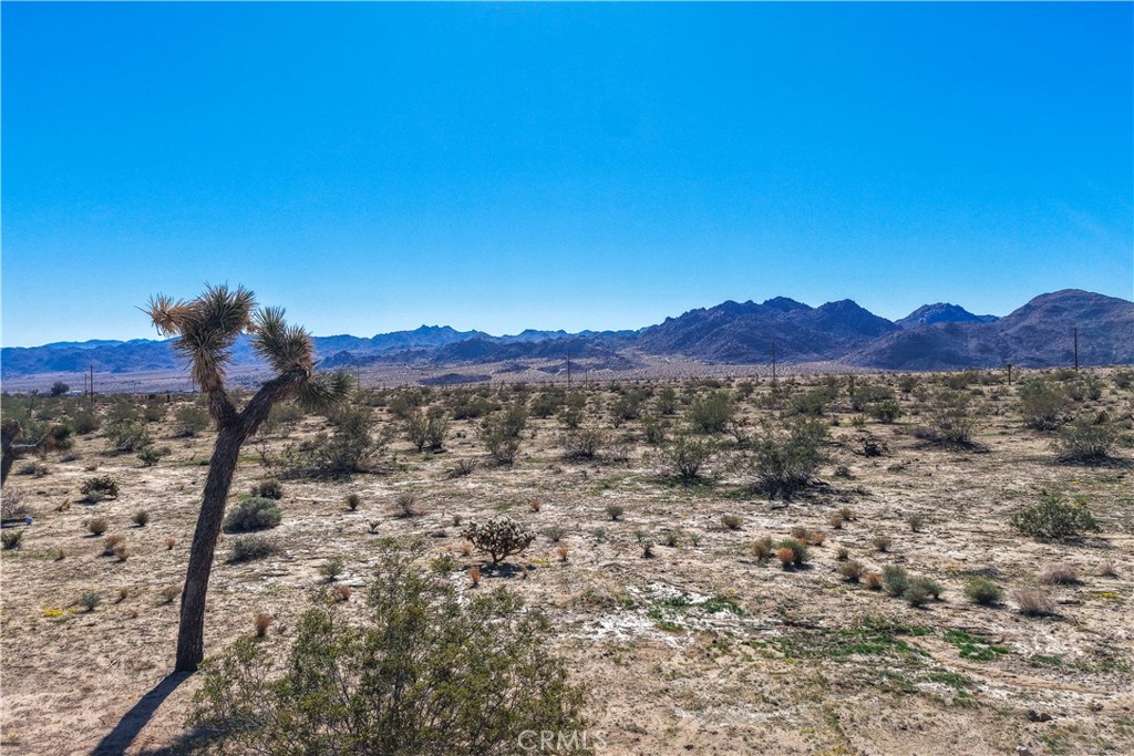 Spacious 18,000 square foot lot located in the desirable Old Town West area of Joshua Tree. This buildable parcel offers an ideal setting for a custom home, vacation retreat, or investment property. Enjoy panoramic desert and mountain views in a peaceful residential setting just minutes from downtown Joshua Tree. Utilities are believed to be available at the street—buyer to verify.
Perfectly positioned near the vibrant heart of Joshua Tree, you’ll be close to local cafés, art galleries, live music, and community events such as the Joshua Tree Music Festival and the weekly Farmers Market. With Joshua Tree National Park just a short drive away, this property combines convenience with the best of the Hi-Desert lifestyle.