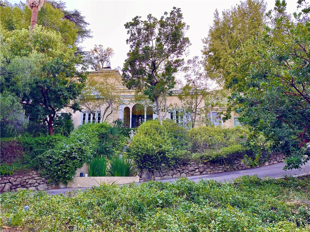 A Rare Hollywood Gem
Discover a nearly 3-acre historical estate in the heart of Hollywood. This 1920s Mediterranean-Revival mansion, approximately 3,300 sq ft, features large French doors and windows, embracing lush natural surroundings. The property includes a 2,200 sq ft guest house, formerly home to the Hollywood Art Center School. Enjoy hiking trails, waterfalls, arbors, and views of the Hollywood sign. The estate's outdoor amphitheater seats 60. Located just five minutes from the Hollywood Bowl and New Hollywood, this unique property offers a blend of history, nature, and modern living.
The main residence is a legendary classic with gracious comfort and scale. The guest house bungalow and studio provide a serene and relaxing space. Living here evokes an era of beauty, fashion, and refinement. This is a truly unique and exceptional offering, perfect for those seeking a blend of history, nature, and modern living. Additionally, the property holds potential for repurposing or redevelopment, subject to approval by the City of Los Angeles. This opens up opportunities for creating new residential lots or other developments, making it a versatile investment.