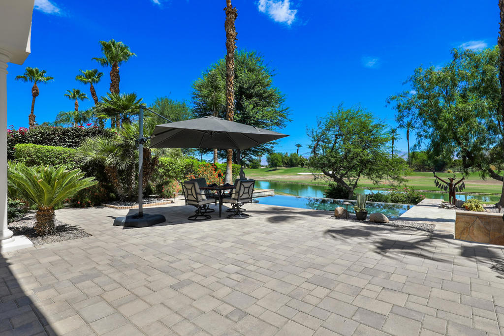 Welcome to Rancho La Quinta Country Club -- The Premier Desert ChoiceDiscover the perfect blend of luxury, privacy, and resort-style living in this beautifully upgraded Encanto II home, ideally situated on a prime elevated lot overlooking a tranquil lake and the 2nd Fairway of the Pate Golf Course -- one of two courses at Rancho La Quinta.Step through the gated front entry into a peaceful courtyard with a soothing water feature and a flexible two-room guest casita, offering comfort and privacy for guests or a dedicated retreat space. Inside the main home, you'll find a spacious formal living room and dining area with soaring ceilings and a dramatic fireplace -- perfect for entertaining or cozy evenings.The stunning great room invites casual elegance, featuring a sleek slate-style fireplace, with a large media TV, and open flow into the newly renovated gourmet kitchen. Designed for both beauty and function, the kitchen boasts luxury porcelain island, countertops and backsplash by Costentino which are sylishly matte-finished. New double ovens with air fry and Sous Vide, plus a new French door refrigerator.Enjoy seamless indoor-outdoor living with a resort-style backyard featuring an infinity-edge Pebble-Tec pool with sun shelf, built-in BBQ area, and breathtaking views of the lake and fairway. The elevated lot provides added privacy while maximizing the scenery.The main residence includes two bedrooms, including a luxurious primary suite with spa-like bath, dual vanities, a spacious shower, and ample natural light. A well-appointed guest bedroom and bathroom complete the layout.The updated detached casita features new porcelain flooring, fresh paint, and a versatile layout with a Jack and Jill bathroom connecting the two rooms -- ideal for visitors, a home office, or studio.Designated laundry room with new washer and dryer. New garage door, remote access.Offered partially furnished per inventory, this exquisite home is ready for you to enjoy the best of desert living at Rancho La Quinta Country Club.