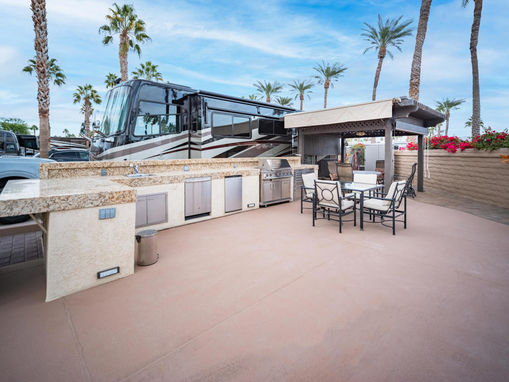 After a fun evening at the clubhouse, retreat to your private oasis at Outdoor Resort Indio. This quiet, perimeter lot is ideal for entertaining, with a spacious outdoor kitchen featuring granite tile countertops, stainless appliances, a large BBQ, and a 10x10 pergola with an aluminum roof. Custom furniture covers, exterior lighting, a ceiling fan, and manual and electric shades ensure comfort and style.The lot accommodates a 45-foot motorcoach and two cars, with tasteful landscaping adding to its charm. Conveniently located near the pool, sauna, and laundry, it combines privacy with easy access to amenities.As a lot owner, you'll also enjoy world-class resort features, including an executive golf course, clubhouse, pickleball courts, and more. This is your opportunity to own a stunning retreat and embrace the luxury RV lifestyle at Outdoor Resort Indio.‍