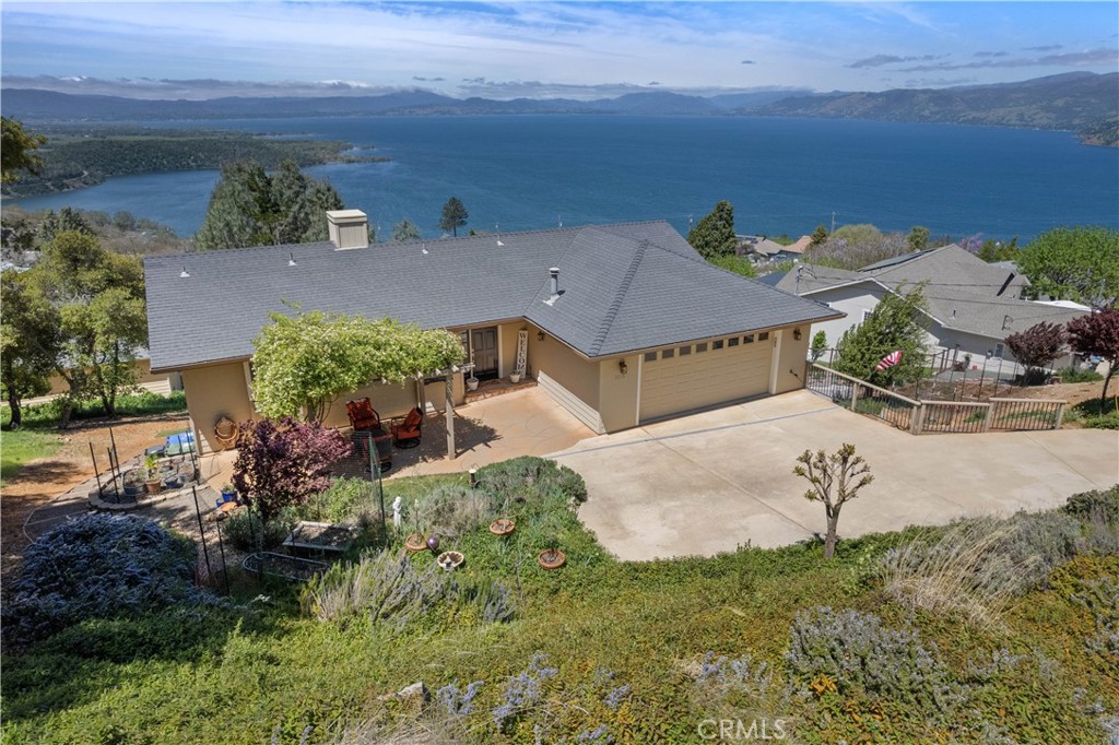 Mesmerizing views and high quality finishes throughout the entire home. 3 bedrooms, 2 baths, double decks, fenced in back yard & garden. Welcome to this bright and inviting home with stunning views of Clear Lake. The foyer welcomes you into the open concept living & dining room with attached "trex" deck. A great space for entertaining. The chef's kitchen is sure to impress with beautiful views, high vaulted ceilings, recessed lighting and stainless steel appliances. The downdraft extractor fan was designed to keep an unobstructed view and allow for interaction between the chef and guests. On the main floor is the primary suite, with a private balcony, and ensuite bathroom complete with separate tub & shower. Wake up to the sunrise, do your sun salutations or have a cup of coffee on your private balcony! On the lower level there are two spacious bedrooms and one full bath. The bath was recently updated with a new marble counter vanity. Guest room 1 has a walk in closet and access to the deck and back yard. Guestroom 2, is very spacious and is currently being used as an office for its abundant natural light. In addition to the storage space available in the 2 car attached garage there is approximately 500 to 700 square feet of storage available in the unfinished basement. Linen closets, and a bonus space for arts/crafts downstairs. This home is situated in the great community of Riviera Heights which offers clubhouse, marina and pool access for its residents.