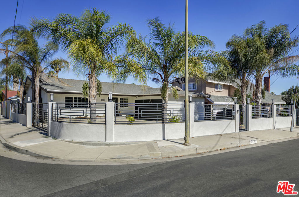 Back on Market! Absolutely delightful picture-perfect Panorama City remodeled home. Positioned on a corner lot in a tranquil pocket of this residential neighborhood, this 3BR/2BA single-story 1960s home features a gated driveway and front yard, hardwood flooring throughout, and recently remodeled kitchens and bathrooms. Tremendous backyard with multiple entertaining areas and outdoor kitchen ideal for all of your gatherings large and small. An elegant foyer leads you into the light-filled formal living room with marble gas fireplace and recessed lighting, followed by an impressively spacious dining room. Next up is the remarkable cook's kitchen boasting large center island perfect for meal preparation, newer stainless-steel appliances, and custom cabinetry with plenty of storage space. Down the hallway you'll discover 3 lovely bedrooms plus an additional room offering versatility as a home office, gym, playroom or walk-in closet. Enjoy two fully remodeled, spacious bathrooms, one of which is ensuite. This special home's upgrades include newer flooring throughout, dual pane windows, baseboards, dedicated laundry room with side-by-side washer/dryer and prep area, central HVAC, updated copper plumbing and gas lines, and tankless water heater. Ample parking for at least 3 cars on the driveway behind the front gate plus home security camera system for added protection. Newer French doors will beckon you to the dynamite low maintenance gated hardscaped backyard, which also includes a built-in island kitchen, large stone pavers and an inviting lounge/relaxation area covered with pergola to shade from the sun. This is truly a warm space to relish time with friends and family. Enjoy close proximity to nearby freeways making your morning commute more pleasurable. Minutes from desirable local destinations, including NOHO Arts District, Kaiser Permanente, and sweet neighborhood joints such as Sri Siam Cafe, Cilantro Mexican Grill, Bill's Burgers, Viet Kitchen and El Cocinero, to name just a few. An absolute winner from head to toe this is a wonderful chance to break into the LA housing market with a turnkey home.